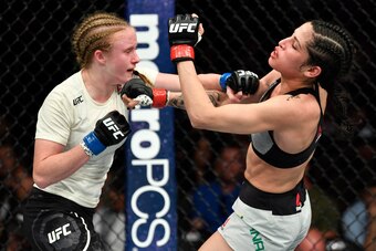 LOS ANGELES, CA - AUGUST 04:  (L-R) JJ Aldrich punches Polyana Viana of Brazil in their women's strawweight fight during the UFC 227 event inside Staples Center on August 4, 2018 in Los Angeles, California. (Photo by Jeff Bottari/Zuffa LLC/Zuffa LLC via G