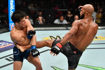 LOS ANGELES, CA - AUGUST 04:  (R-L) Demetrious Johnson kicks Henry Cejudo in their UFC flyweight championship fight during the UFC 227 event inside Staples Center on August 4, 2018 in Los Angeles, California. (Photo by Jeff Bottari/Zuffa LLC/Zuffa LLC via