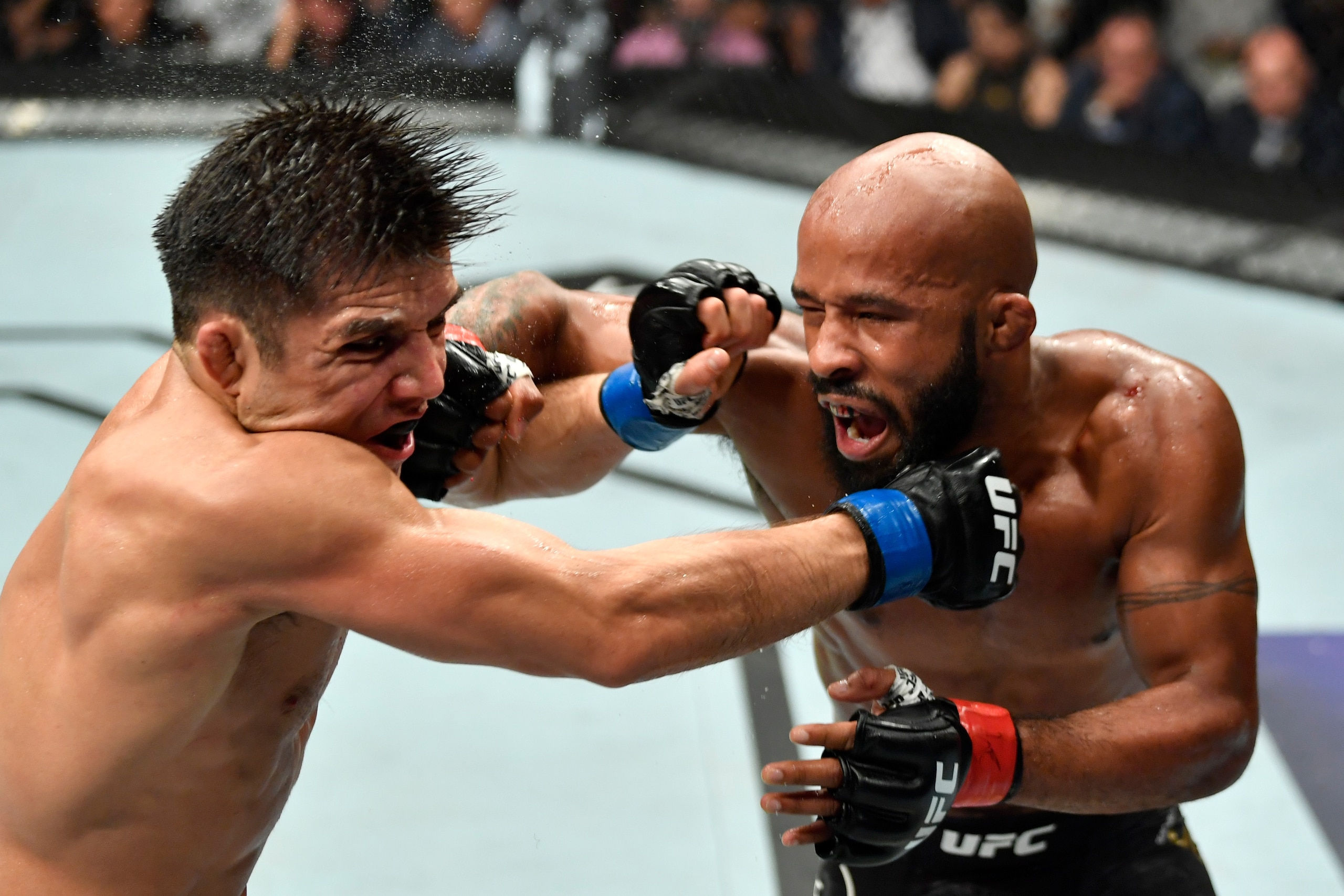 LOS ANGELES, CA - AUGUST 04:  (R-L) Demetrious Johnson punches Henry Cejudo in their UFC flyweight championship fight during the UFC 227 event inside Staples Center on August 4, 2018 in Los Angeles, California. (Photo by Jeff Bottari/Zuffa LLC/Zuffa LLC v