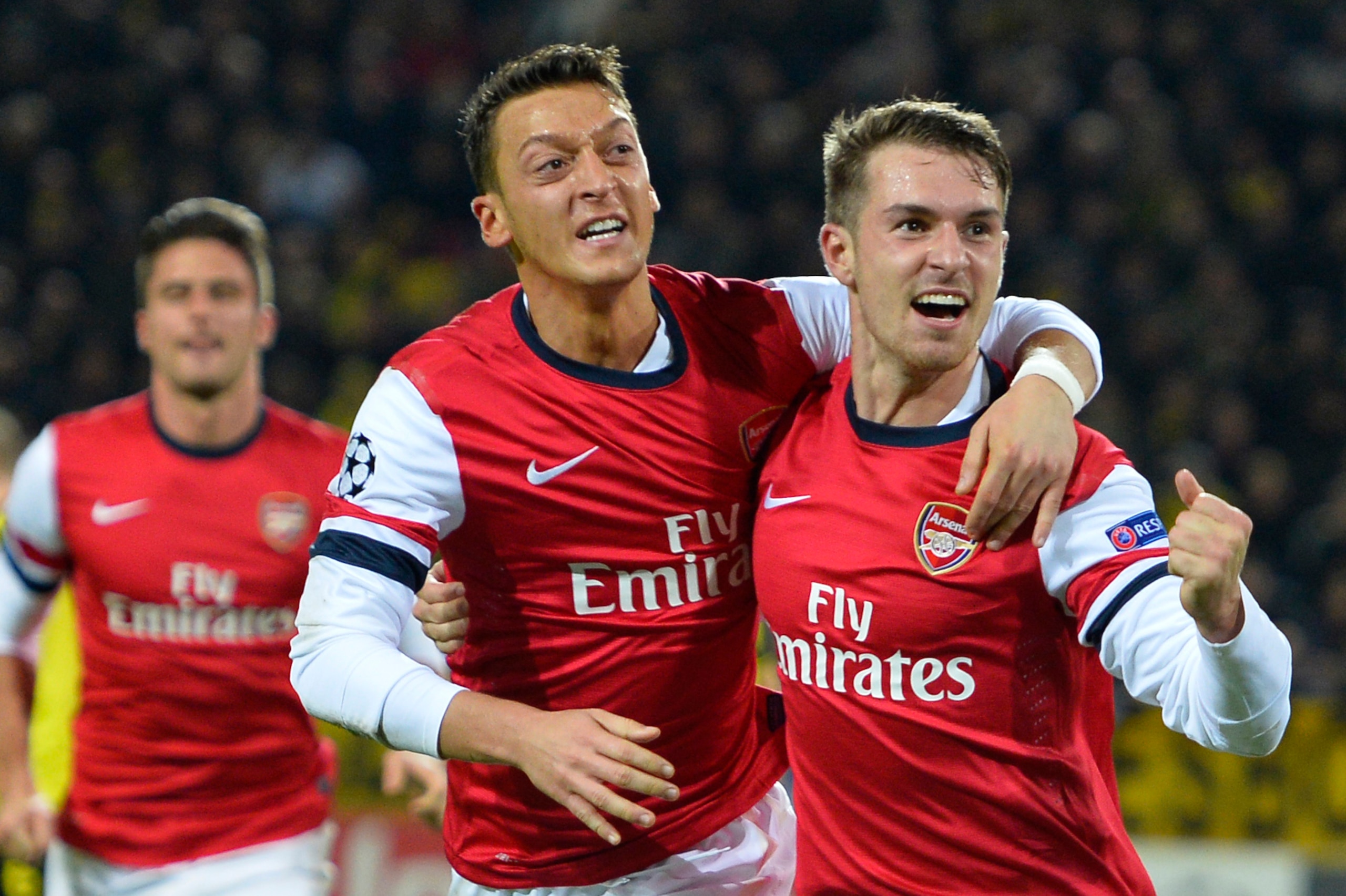 Arsenal's Welsh midfielder Aaron Ramsey (R) celebrates scoring the opening goal with Arsenal's German midfielder Mesut Ozil during the UEFA Champions League group F football match Borussia Dortmund vs Arsenal London in Dortmund, western Germany on Novembe