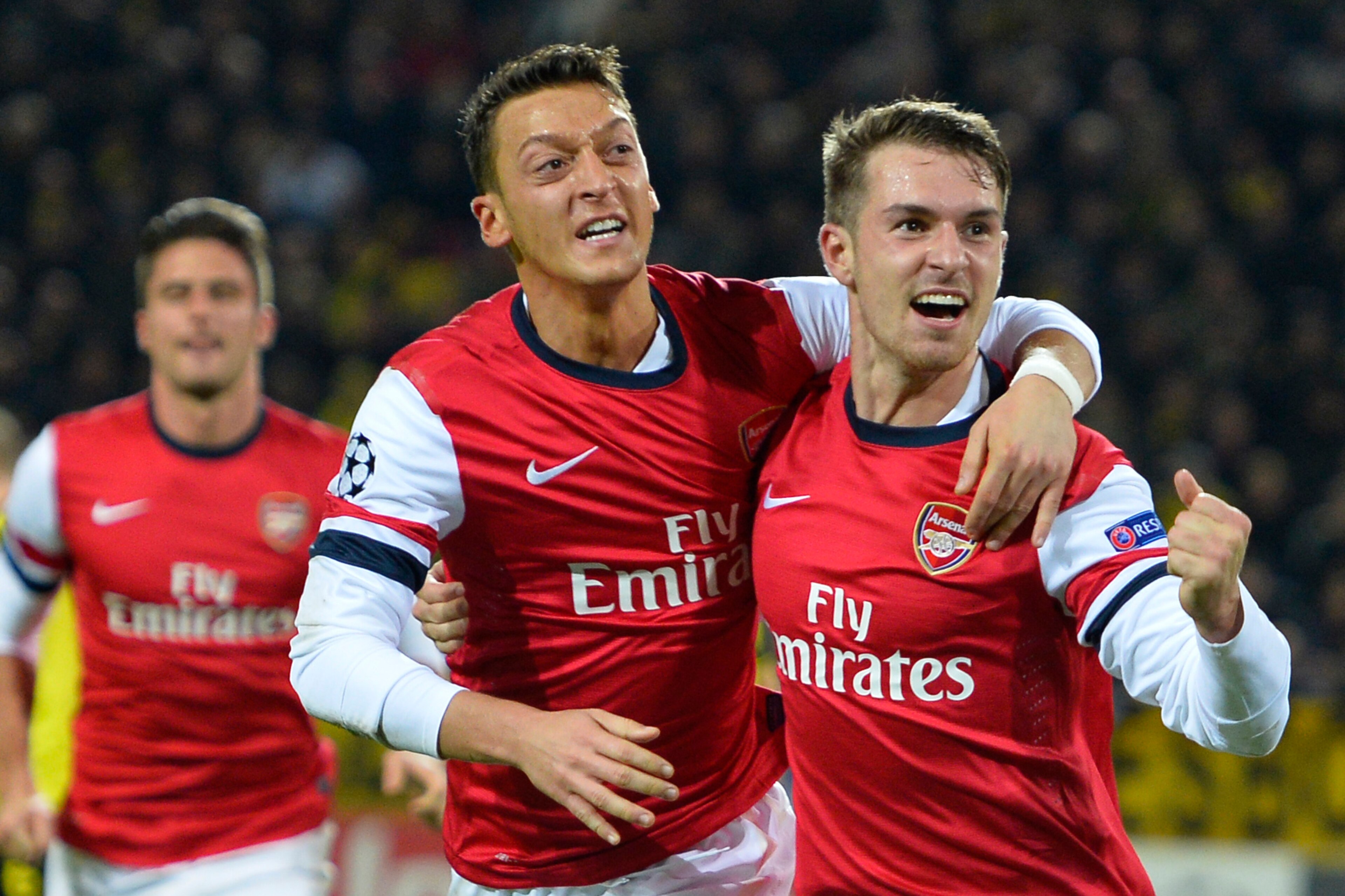 Arsenal's Welsh midfielder Aaron Ramsey (R) celebrates scoring the opening goal with Arsenal's German midfielder Mesut Ozil during the UEFA Champions League group F football match Borussia Dortmund vs Arsenal London in Dortmund, western Germany on Novembe
