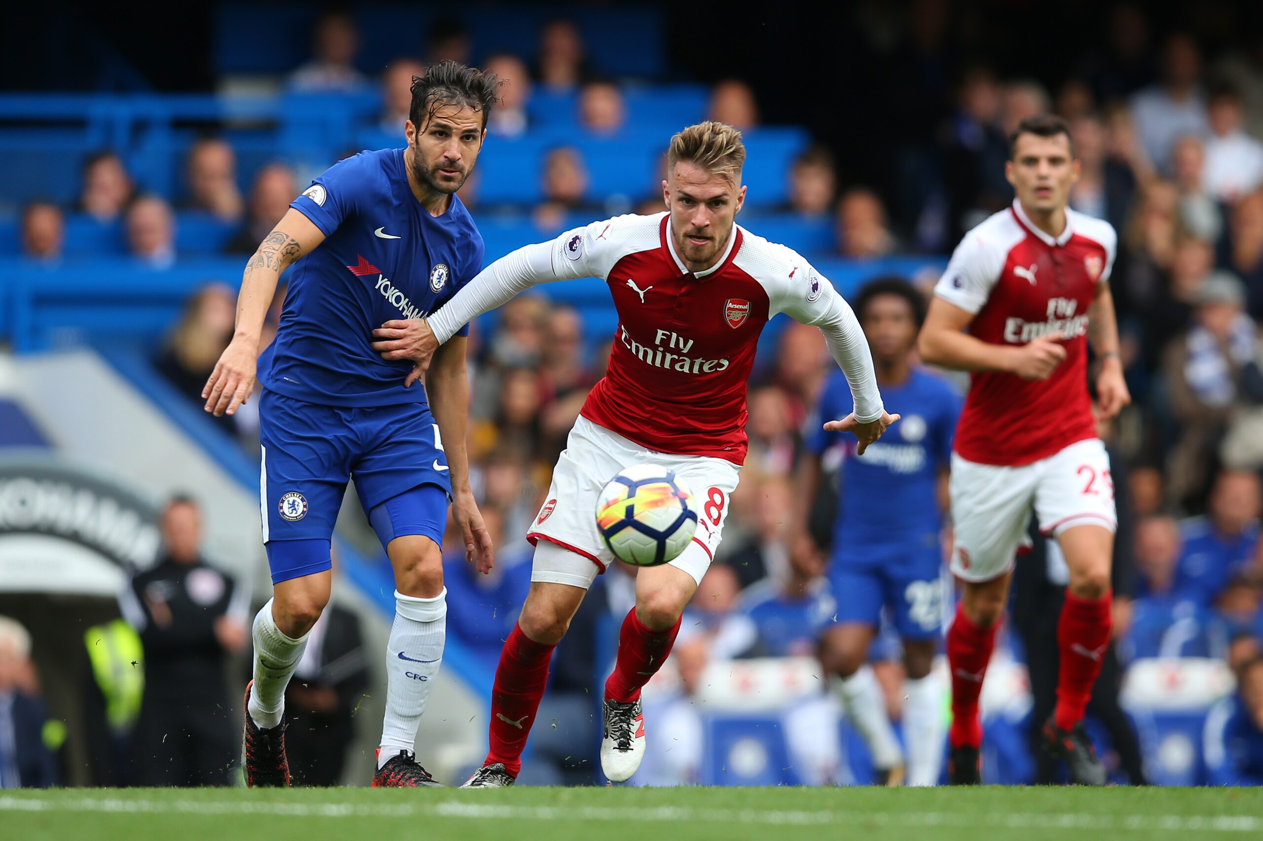 LONDON, ENGLAND - SEPTEMBER 17: Cesc Fabregas of Chelsea and Aaron Ramsey of Arsenal during the Premier League match between Chelsea and Arsenal at Stamford Bridge on September 17, 2017 in London, England. (Photo by Catherine Ivill - AMA/Getty Images)