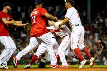 BOSTON, MA - AUGUST 5: Andrew Benintendi #16 of the Boston Red Sox is mobbed by teammates after hitting the game winning walk off single during the tenth inning of a game against the New York Yankees on August 5, 2018 at Fenway Park in Boston, Massachuset