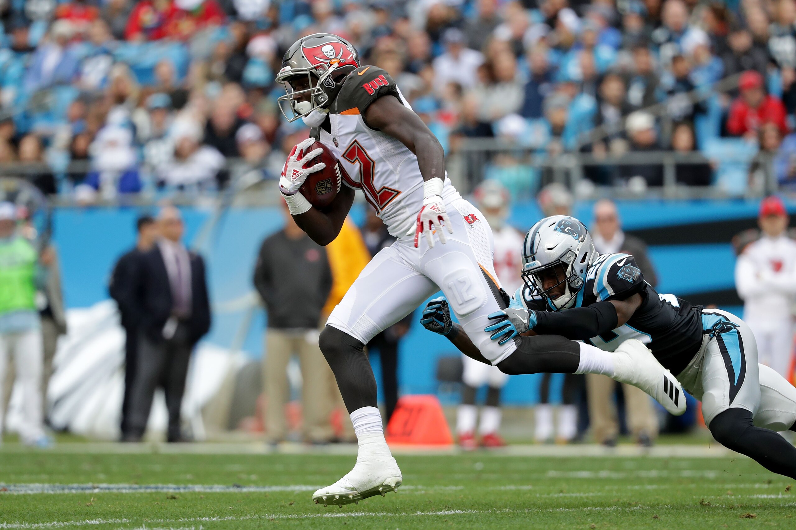 CHARLOTTE, NC - DECEMBER 24:  Chris Godwin #12 of the Tampa Bay Buccaneers runs the ball against the Carolina Panthers in the second quarter during their game at Bank of America Stadium on December 24, 2017 in Charlotte, North Carolina.  (Photo by Streete