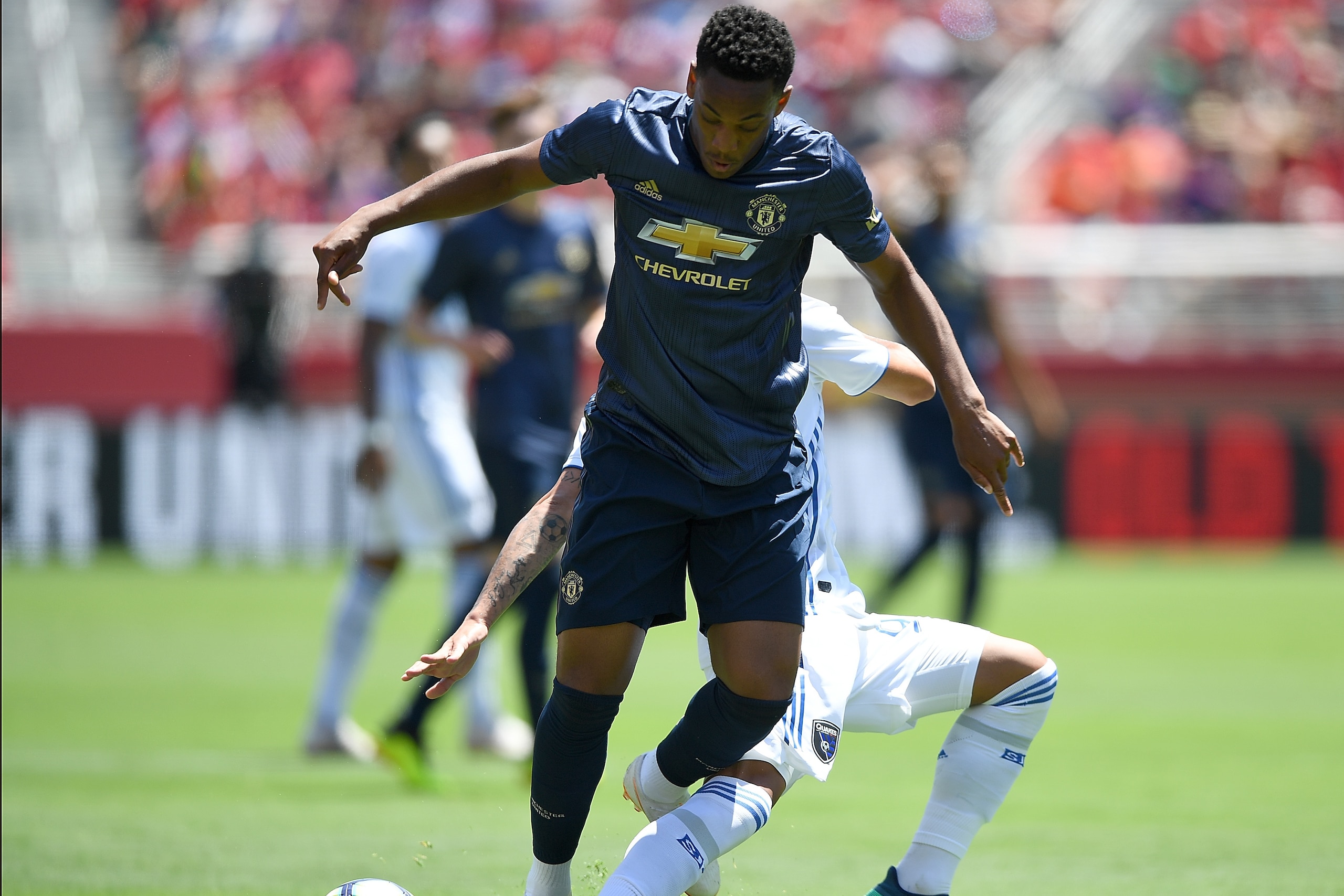 SANTA CLARA, CA - JULY 22:  Anthony Martial #11 of Manchester United battles for contol of the ball with Danny Hoesen #9 of the San Jose Earthquakes during the first half of their exhibition soccer game at Levi's Stadium on July 22, 2018 in Santa Clara, C