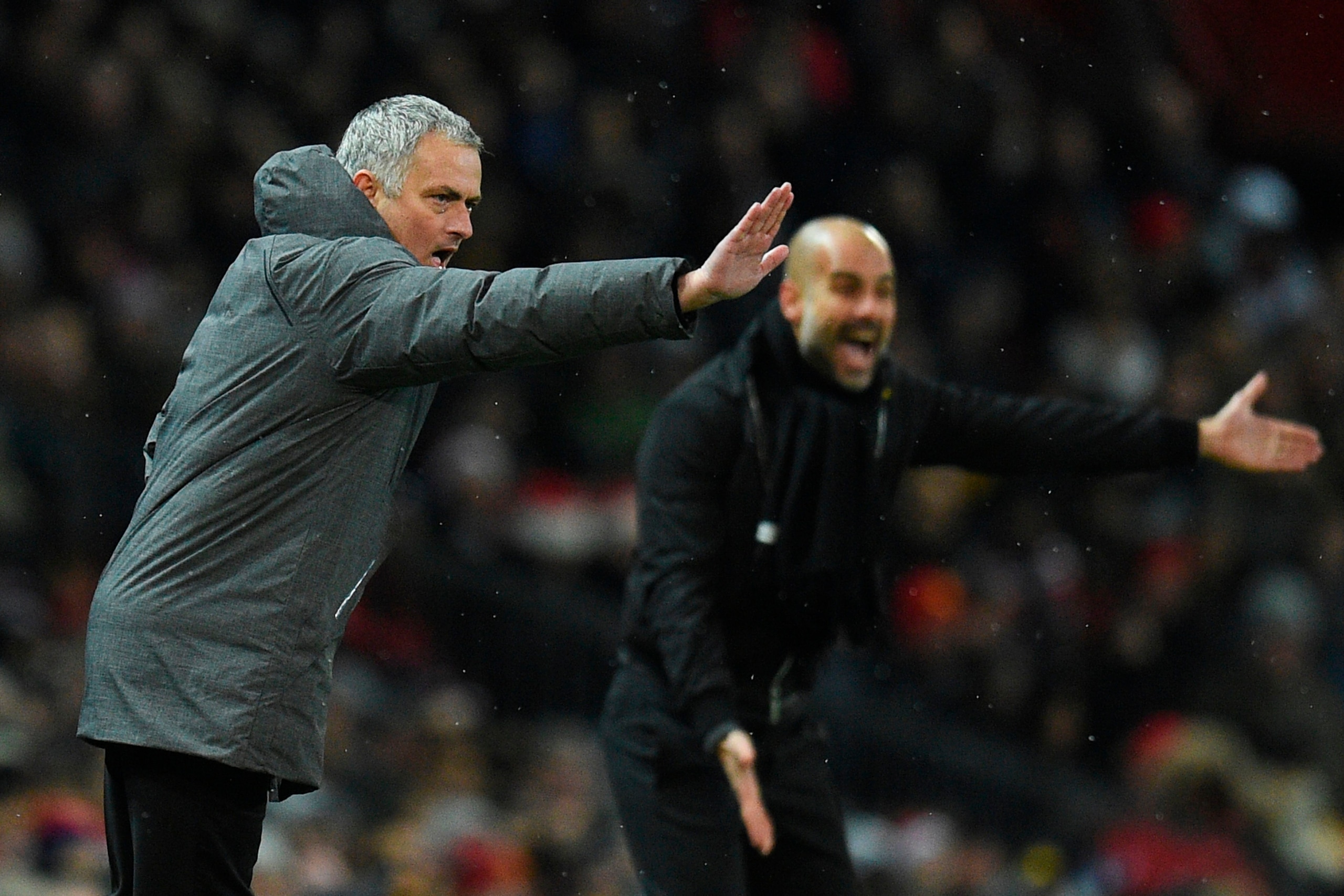 Manchester United's Portuguese manager Jose Mourinho (L) and Manchester City's Spanish manager Pep Guardiola (R) gestures from the touchline during the English Premier League football match between Manchester United and Manchester City at Old Trafford in 