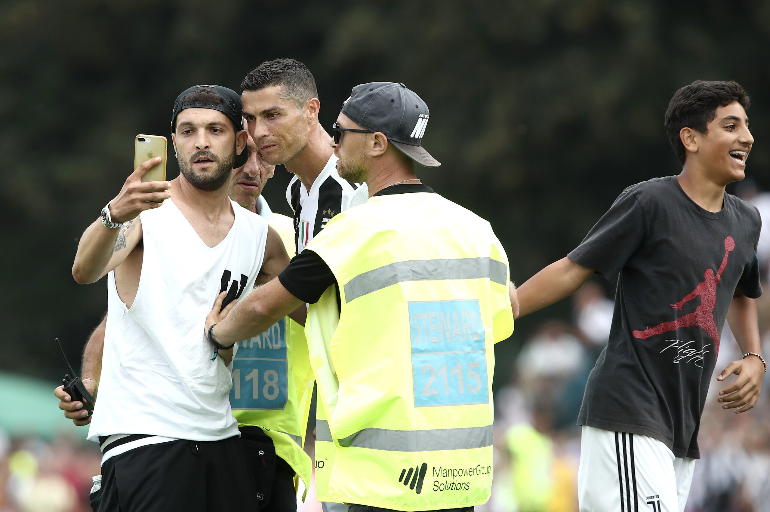 Juventus supporters invaded the pitch to take a picture with Juventus forward Cristiano Ronaldo at the end of the first half of the friendly football match between Juventus A and Juventus B at Villar Perosa, on August 12, 2018 at Villar Perosa. (Photo by 