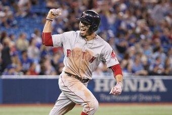 TORONTO, ON - AUGUST 9: Mookie Betts #50 of the Boston Red Sox celebrates as he hits a solo home run to complete the cycle in the ninth inning during MLB game action against the Toronto Blue Jays at Rogers Centre on August 9, 2018 in Toronto, Canada. (Pho