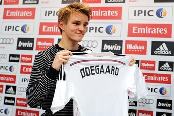 MADRID, SPAIN - JANUARY 22:  Martin Odegaard from Norway holds his new Real Madrid shirt during a press conference at Real Madrid's Valdebebas training grounds after he signed with Real on January 22, 2015 in Madrid, Spain. Odegaard aged 16 will play for 