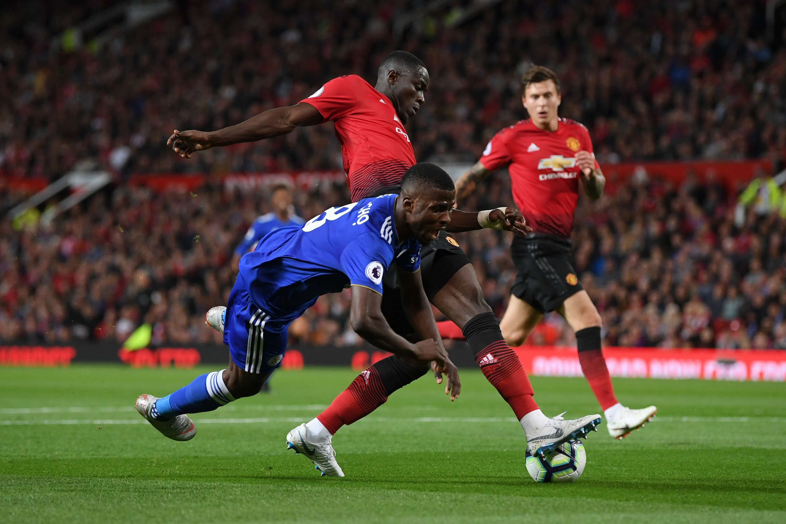 MANCHESTER, ENGLAND - AUGUST 10:  Kelechi Iheanacho of Leicester City goes down under pressure from Eric Bailly of Manchester United during the Premier League match between Manchester United and Leicester City at Old Trafford on August 10, 2018 in Manches