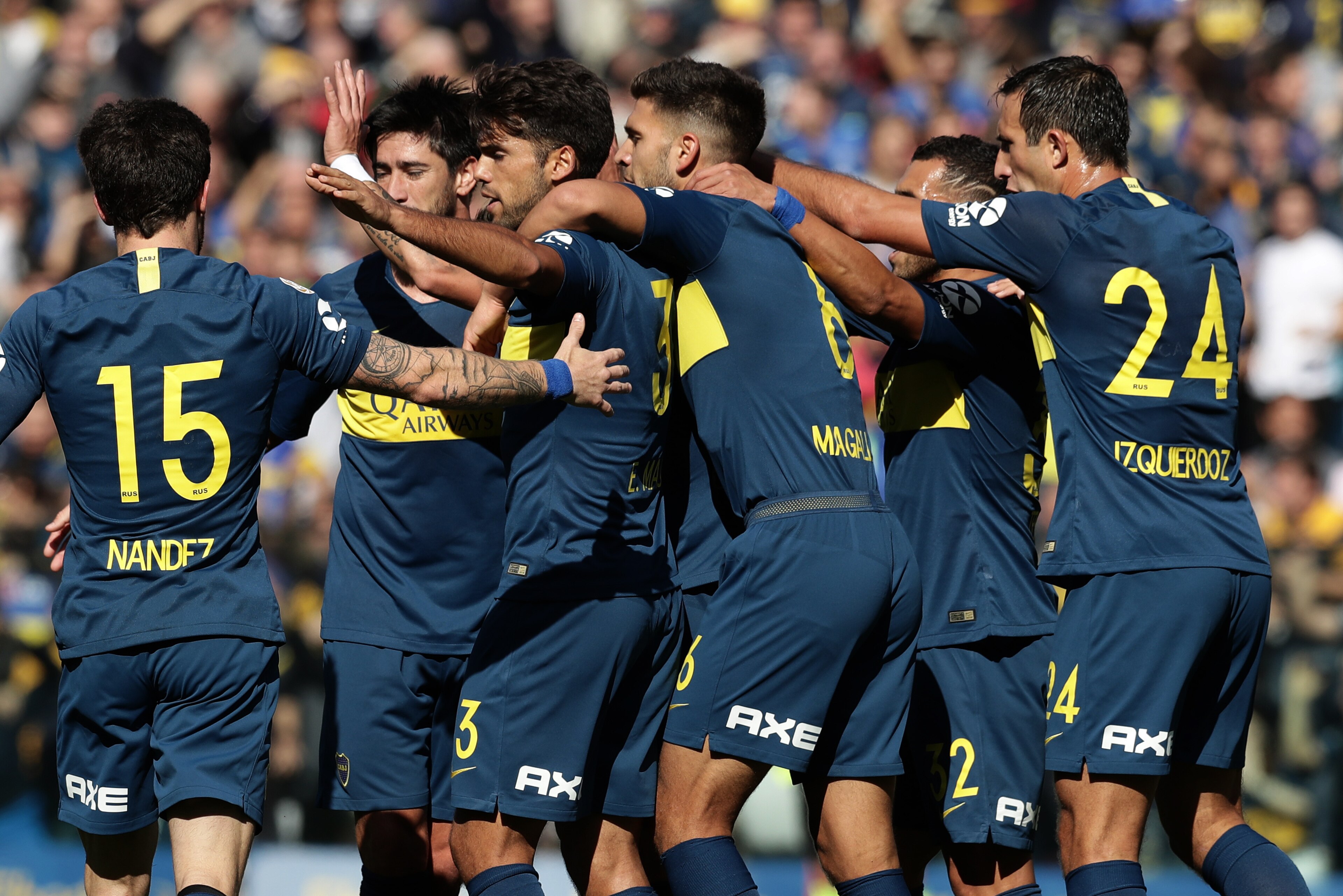 Boca Juniors' forward Cristian Pavon (C, hidden) celebrates with teammates after scoring a goal against Talleres during their Argentinian First Division Superliga football match at La Bombonera stadium, in Buenos Aires, on August 12, 2018. (Photo by ALEJA