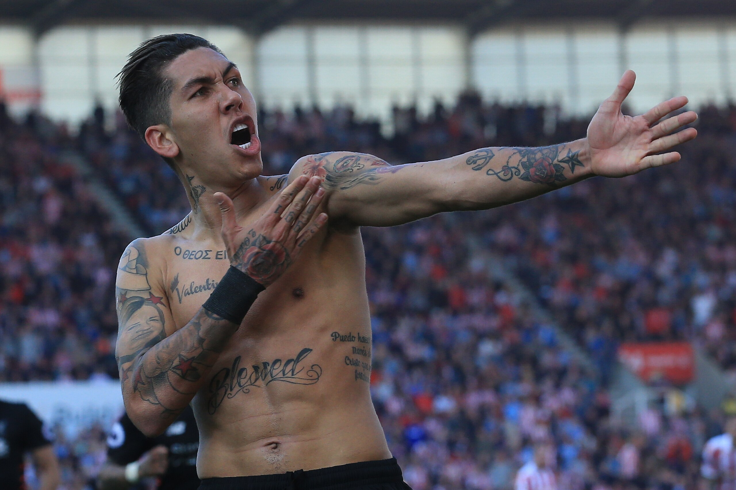Liverpool's Brazilian midfielder Roberto Firmino celebrates scoring his team's second goal during the English Premier League football match between Stoke City and Liverpool at the Bet365 Stadium in Stoke-on-Trent, central England on April 8, 2017. / AFP P