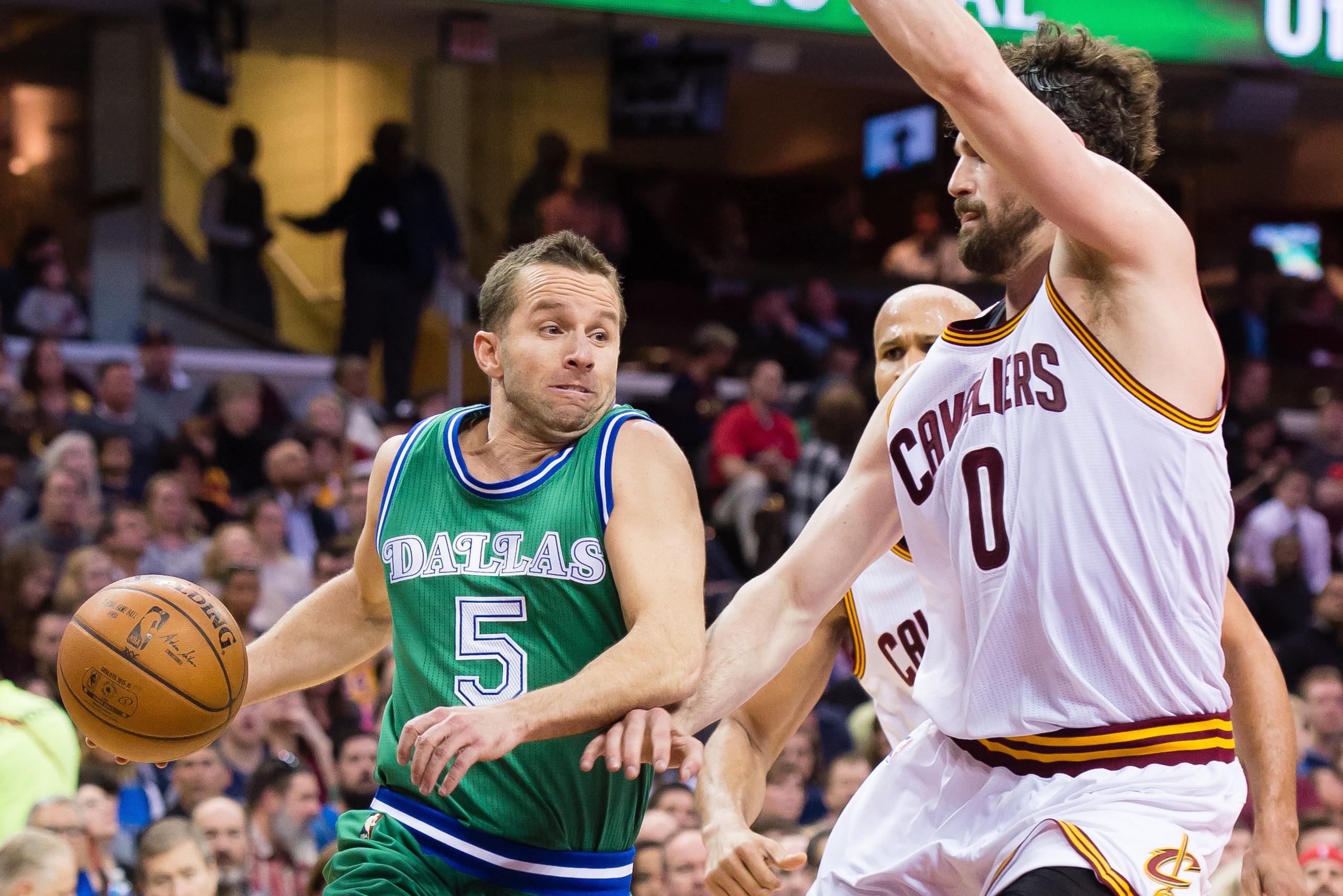 CLEVELAND, OH - MARCH 16: J.J. Barea #5 of the Dallas Mavericks drives around Kevin Love #0 of the Cleveland Cavaliers during the first half at Quicken Loans Arena on March 16, 2016 in Cleveland, Ohio. NOTE TO USER: User expressly acknowledges and agrees 