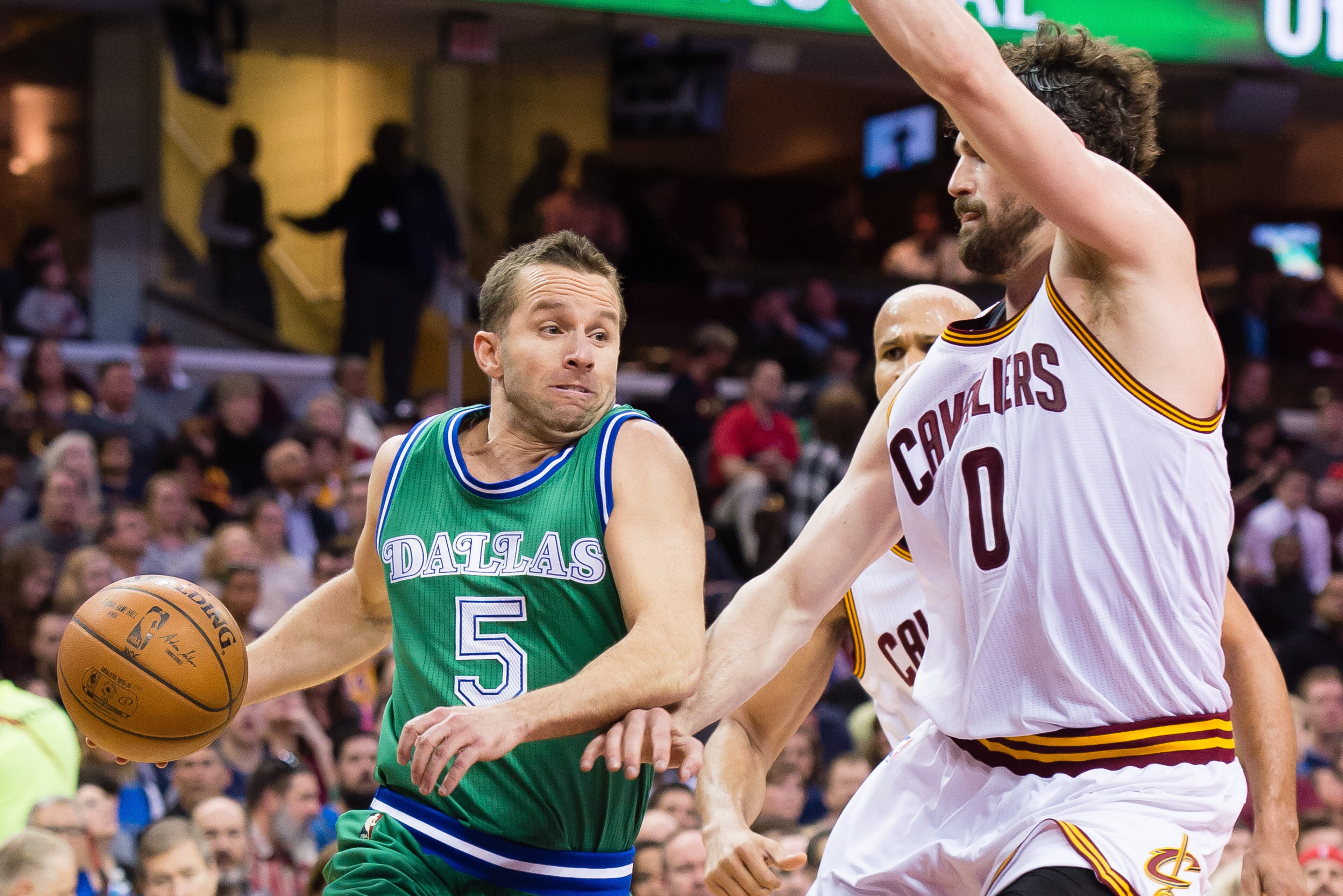 CLEVELAND, OH - MARCH 16: J.J. Barea #5 of the Dallas Mavericks drives around Kevin Love #0 of the Cleveland Cavaliers during the first half at Quicken Loans Arena on March 16, 2016 in Cleveland, Ohio. NOTE TO USER: User expressly acknowledges and agrees 