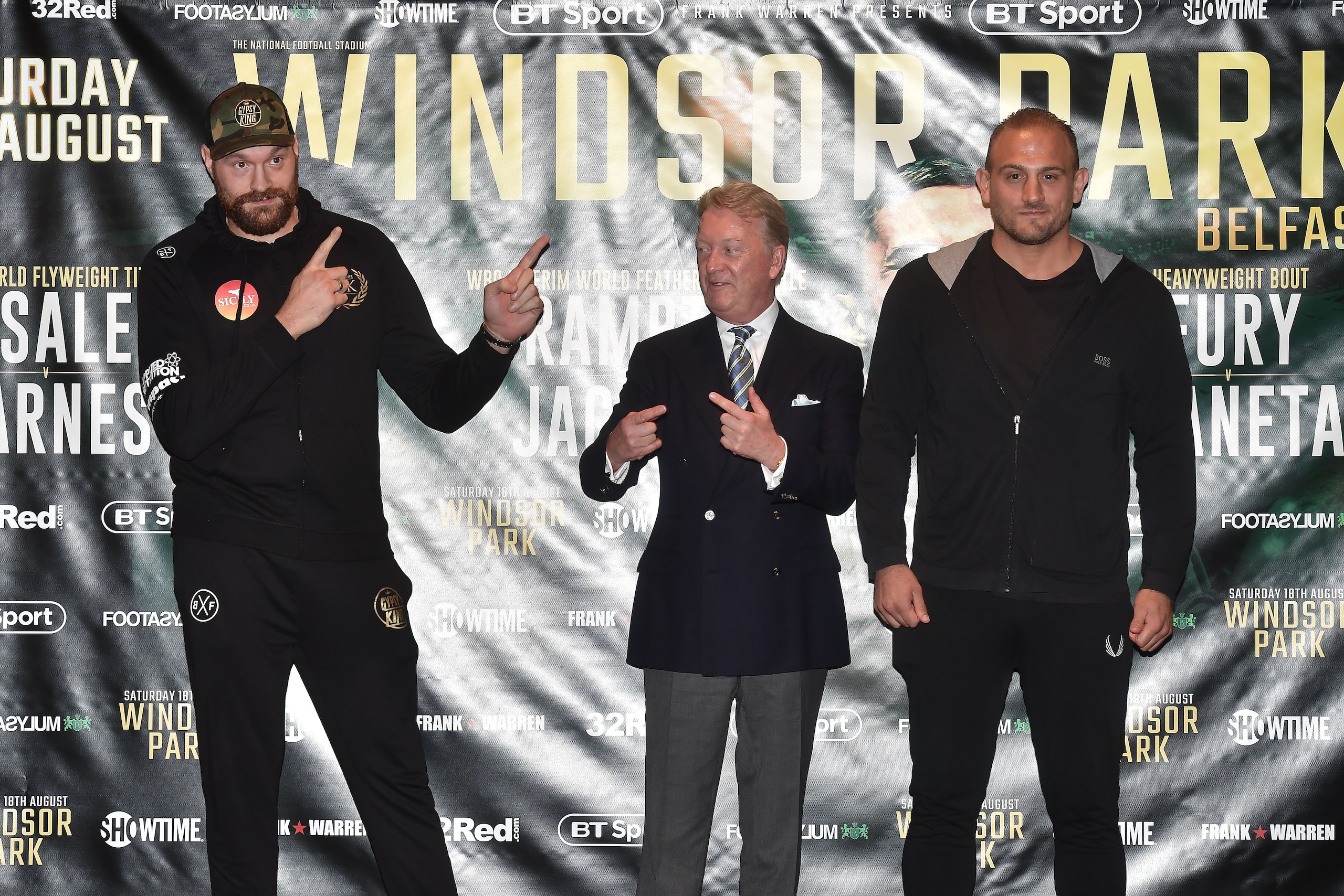 BELFAST, NORTHERN IRELAND - AUGUST 14: Heavyweight boxer Tyson Fury (L) poses with opponent Francesco Pianeta (R) alongside promoter Frank Warren (C) during a pre fight press conference at Europa Hotel on August 14, 2018 in Belfast, Northern Ireland. Fury