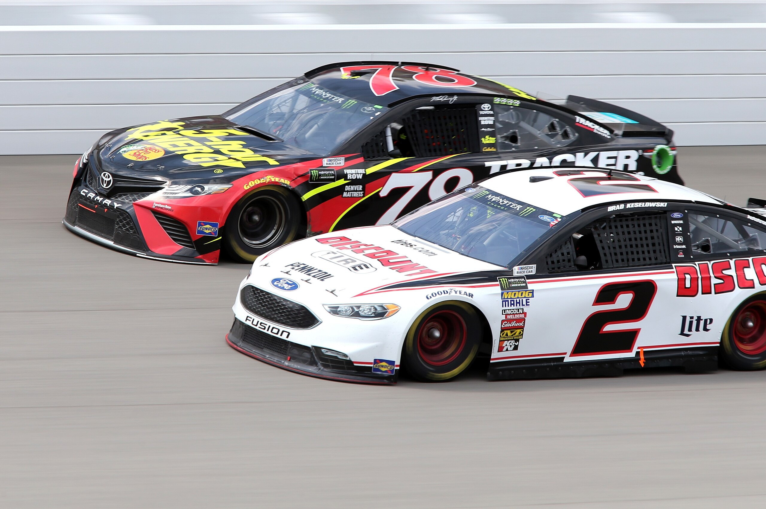 BROOKLYN, MI - AUGUST 12: Martin Truex Jr., driver of the #78 5-hour ENERGY/Bass Pro Shops Toyota, and Brad Keselowski, driver of the #2 Discount Tire Ford, race during the Monster Energy NASCAR Cup Series Consmers Energy 400 at Michigan International Spe