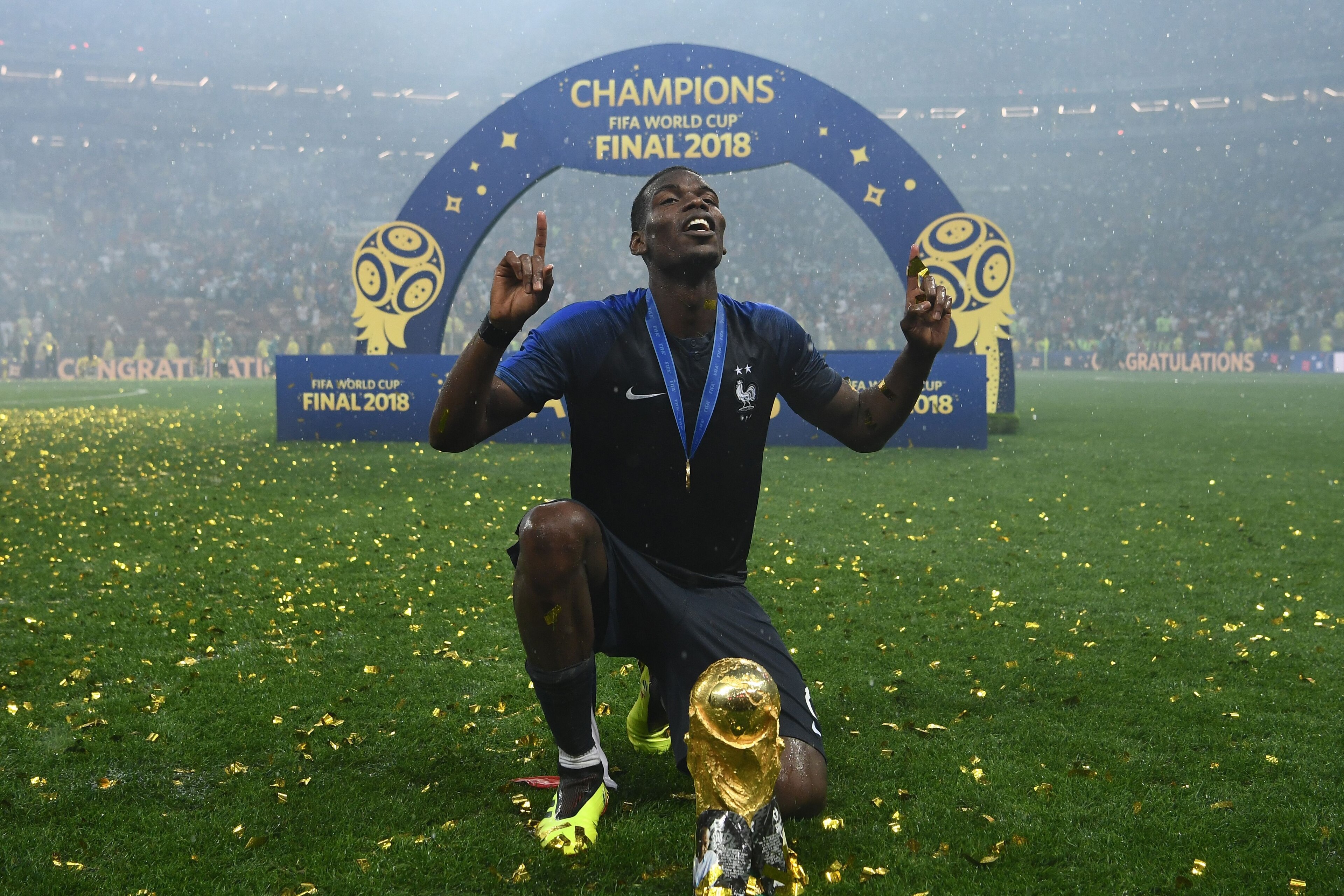 France's midfielder Paul Pogba celebrates with the World Cup trophy after the Russia 2018 World Cup final football match between France and Croatia at the Luzhniki Stadium in Moscow on July 15, 2018. (Photo by FRANCK FIFE / AFP) / RESTRICTED TO EDITORIAL 
