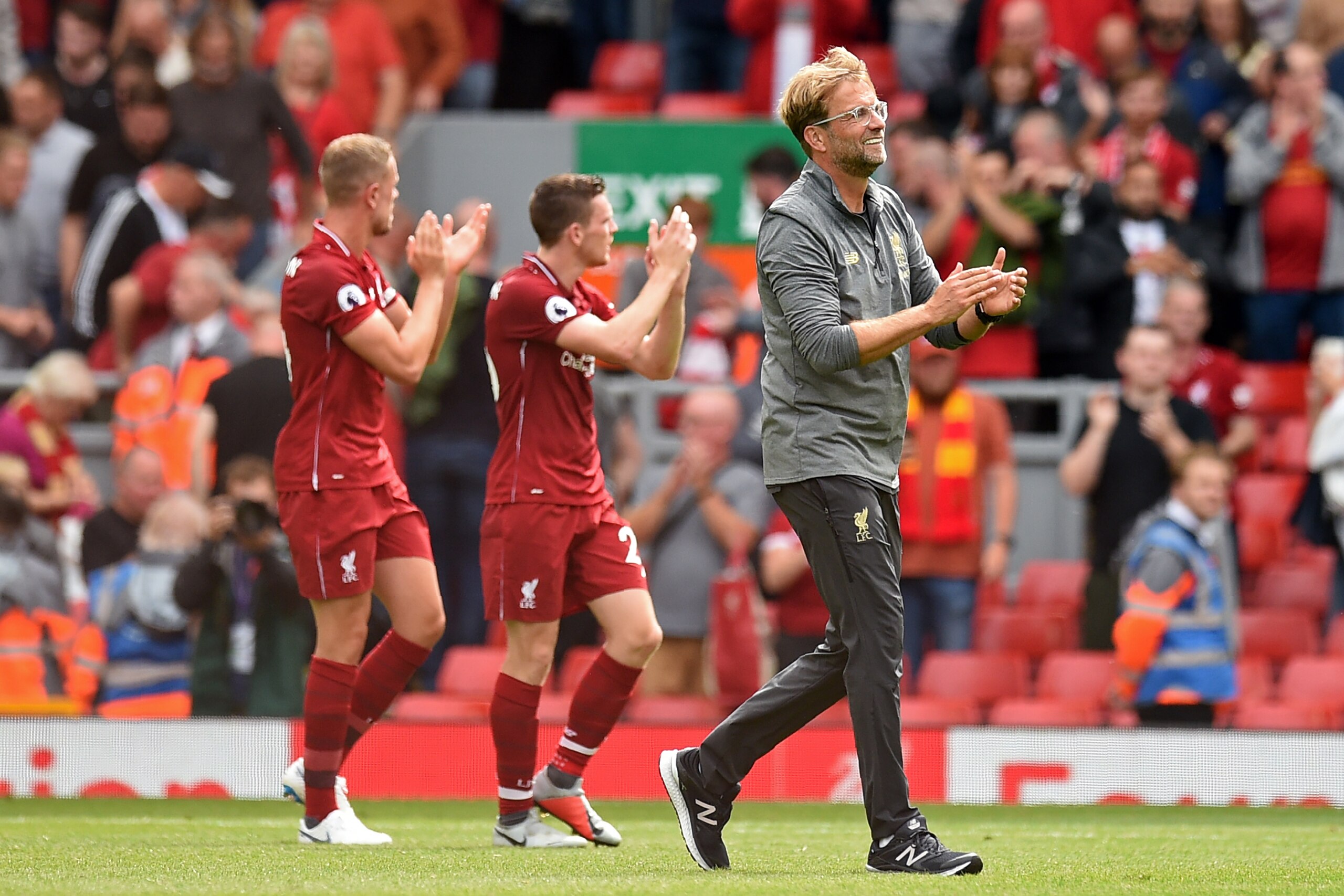 Liverpool's German manager Jurgen Klopp (R) applauds supporters on the pitch after the English Premier League football match between Liverpool and West Ham United at Anfield in Liverpool, north west England on August 12, 2018. (Photo by Oli SCARFF / AFP) 