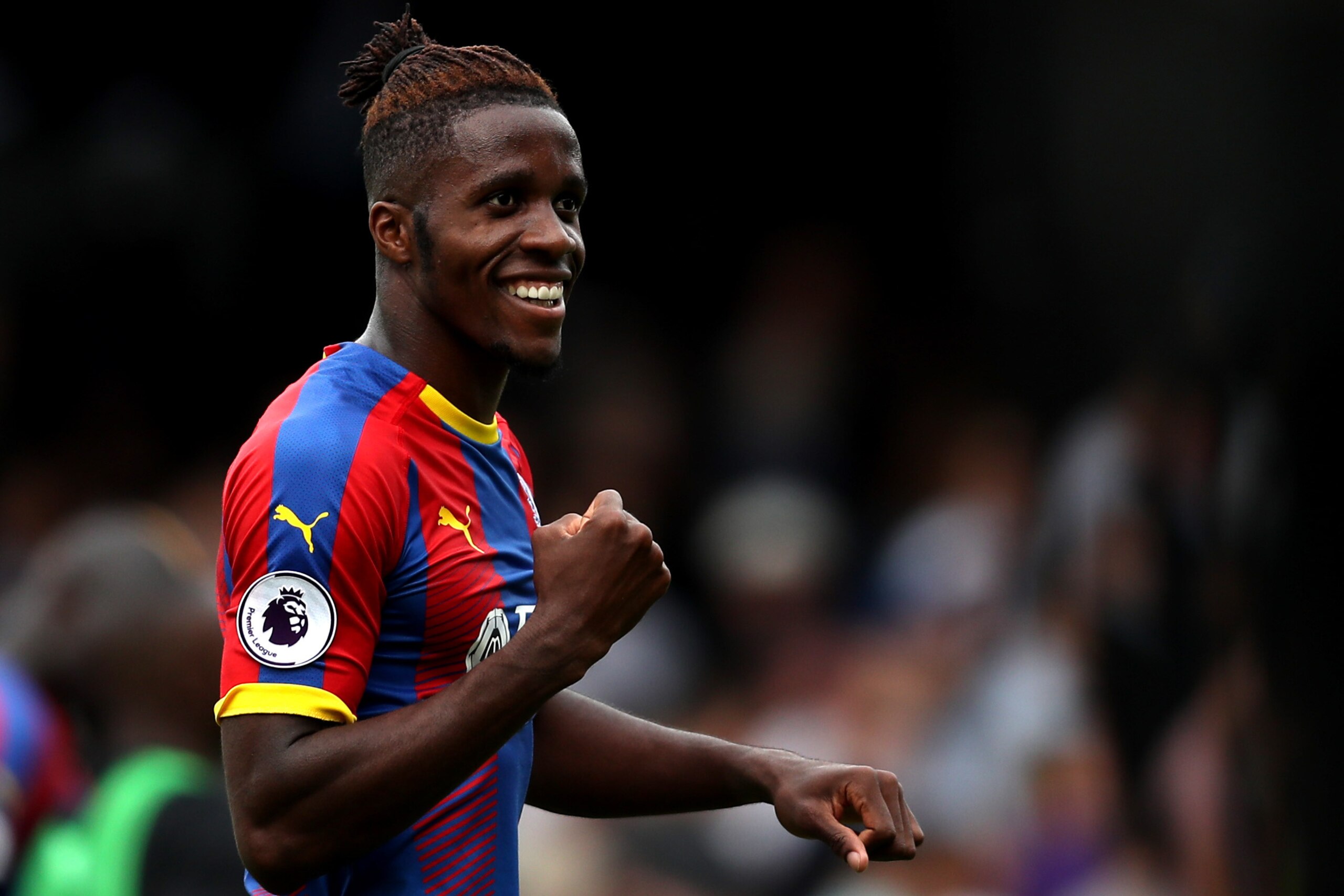 LONDON, ENGLAND - AUGUST 11:  Wilfried Zaha of Crystal Palace celebrates following his sides victory in the Premier League match between Fulham FC and Crystal Palace at Craven Cottage on August 11, 2018 in London, United Kingdom.  (Photo by Christopher Le