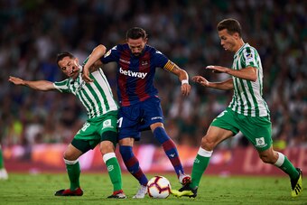 SEVILLE, SPAIN - AUGUST 17: Andres Guardado and Sergio Canales of Real Betis compete for the ball with Jose Luis Morales of Levante UD during the La Liga match between Real Betis Balompie and Levante UD at Estadio Benito Villamarin on August 17, 2018 in S