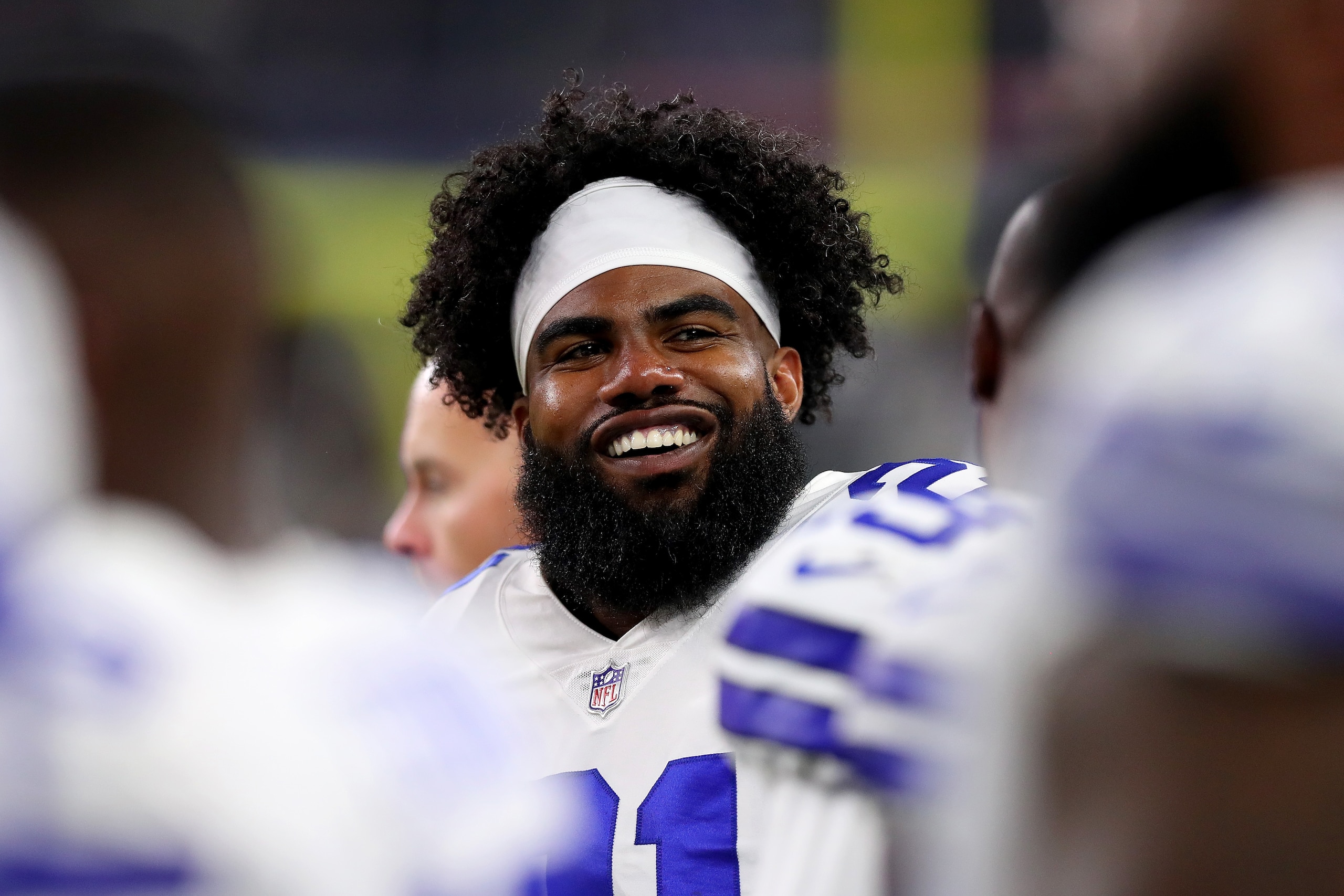 ARLINGTON, TX - AUGUST 18:  Ezekiel Elliott #21 of the Dallas Cowboys looks on from the sidelines as the Dallas Cowboys take on the Cincinnati Bengals in the fourth quarter at AT&T Stadium on August 18, 2018 in Arlington, Texas.  (Photo by Tom Pennington/