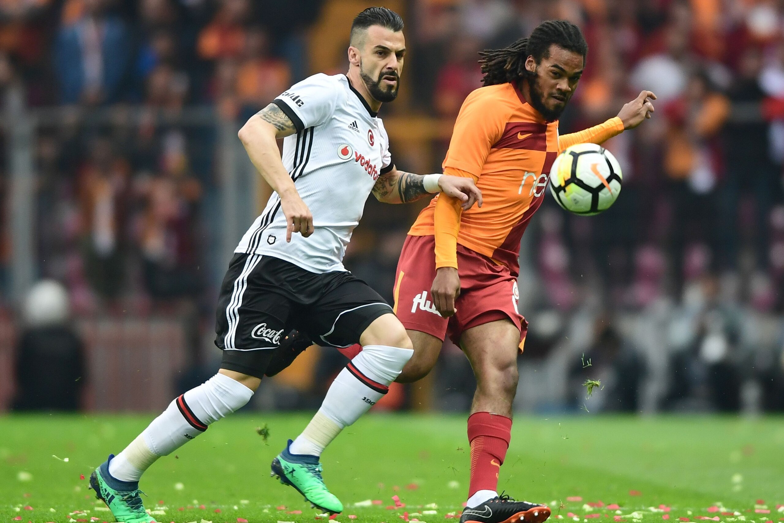 Galatasaray's Belgian defender Jason Denayer (R) vies for the ball with Besiktas' Spanish forward Alvaro Negredo during the Turkish Spor Toto Super league football match between Galataray and Besiktas on April 29, 2018 at the TT Arena stadium in Istanbul.