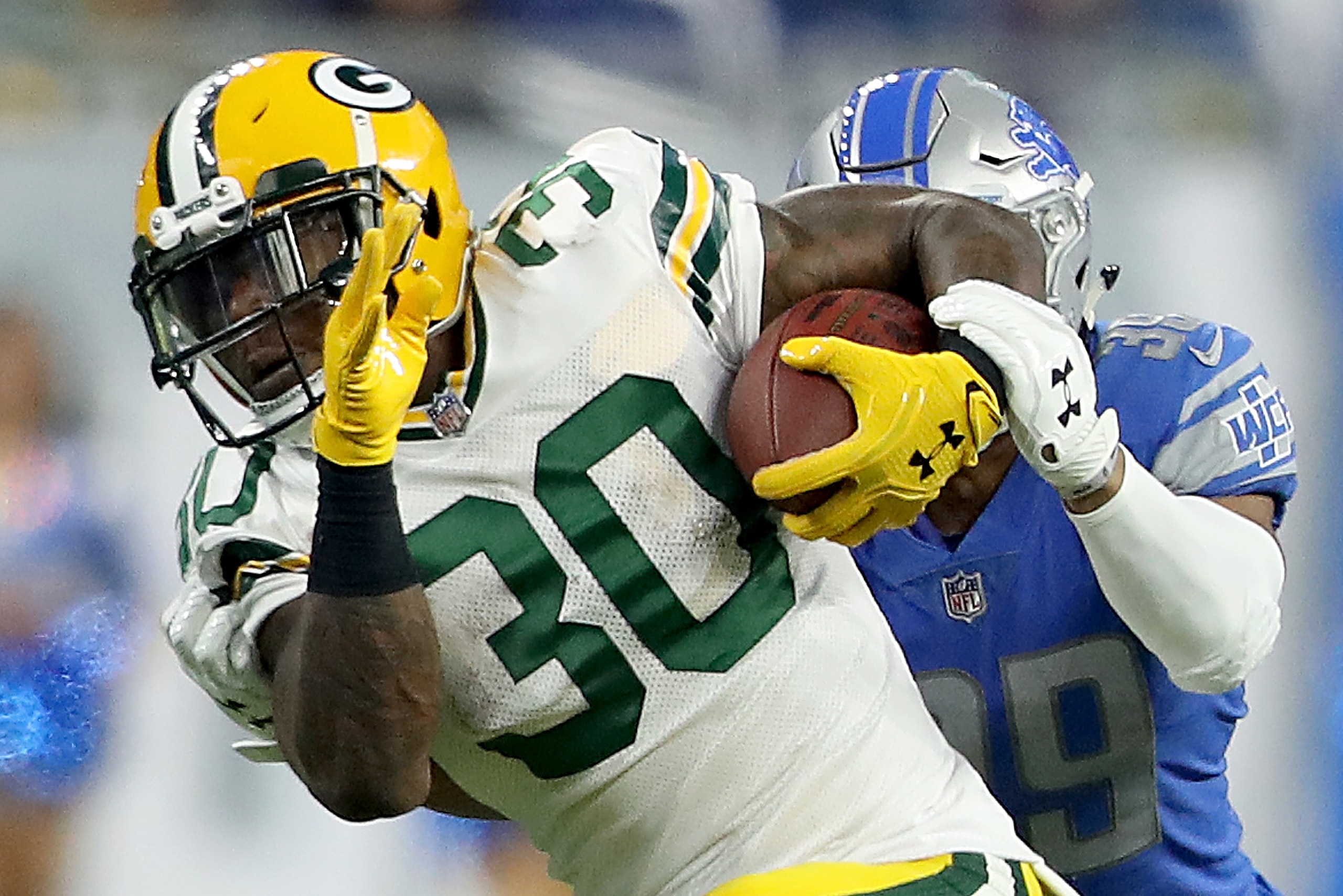 DETROIT, MI - DECEMBER 31: Jamaal Williams #30 of the Green Bay Packers runs with the ball against Jamal Agnew #39 of the Detroit Lions during the first half at Ford Field on December 31, 2017 in Detroit, Michigan. (Photo by Leon Halip/Getty Images)