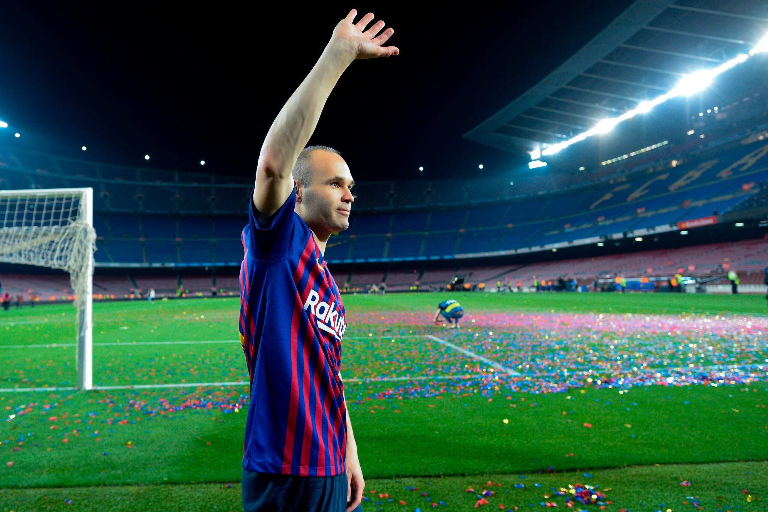 TOPSHOT - Barcelona's Spanish midfielder Andres Iniesta waves at the end of a tribute after the Spanish league football match between FC Barcelona and Real Sociedad at the Camp Nou stadium in Barcelona on May 20, 2018. - Iniesta, who joined Barcelona's ac