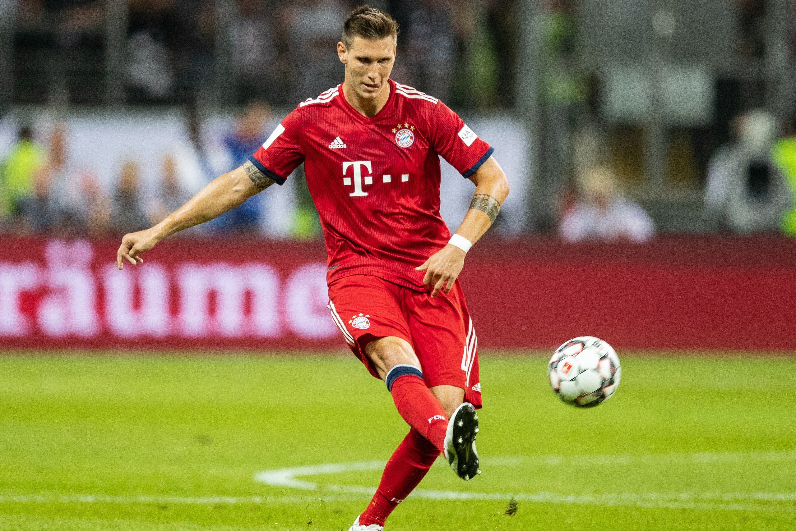 FRANKFURT AM MAIN, GERMANY - AUGUST 12: Niklas Suele of FC Bayern Muenchen runs with the ball during the DFL Supercup 2018 match between Eintracht Frankfurt and Bayern Muenchen at Commerzbank-Arena on August 12, 2018 in Frankfurt am Main, Germany.  (Photo