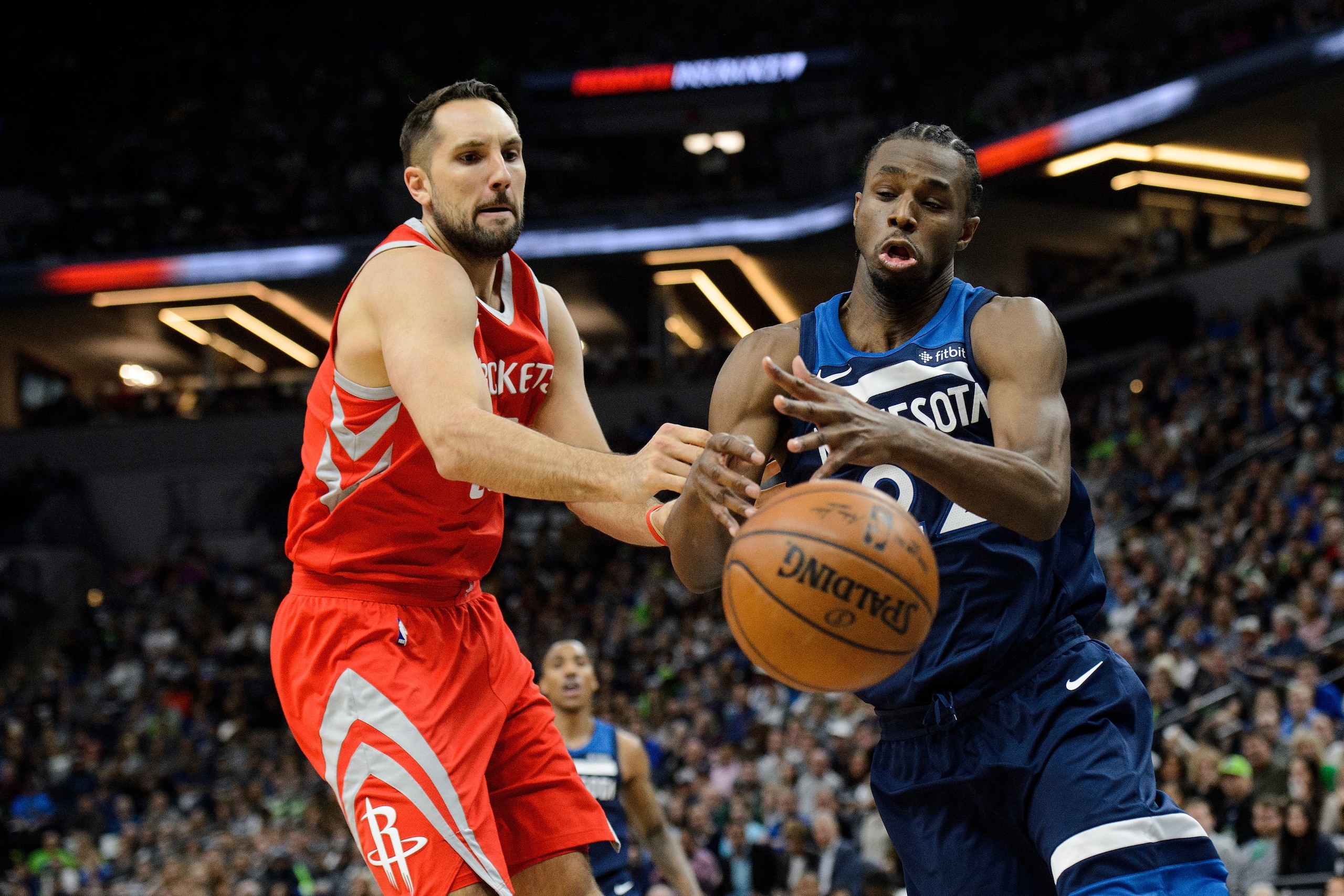 MINNEAPOLIS, MN - APRIL 21: Ryan Anderson #33 of the Houston Rockets knocks the ball away from Andrew Wiggins #22 of the Minnesota Timberwolves in Game Three of Round One of the 2018 NBA Playoffs on April 21, 2018 at the Target Center in Minneapolis, Minn