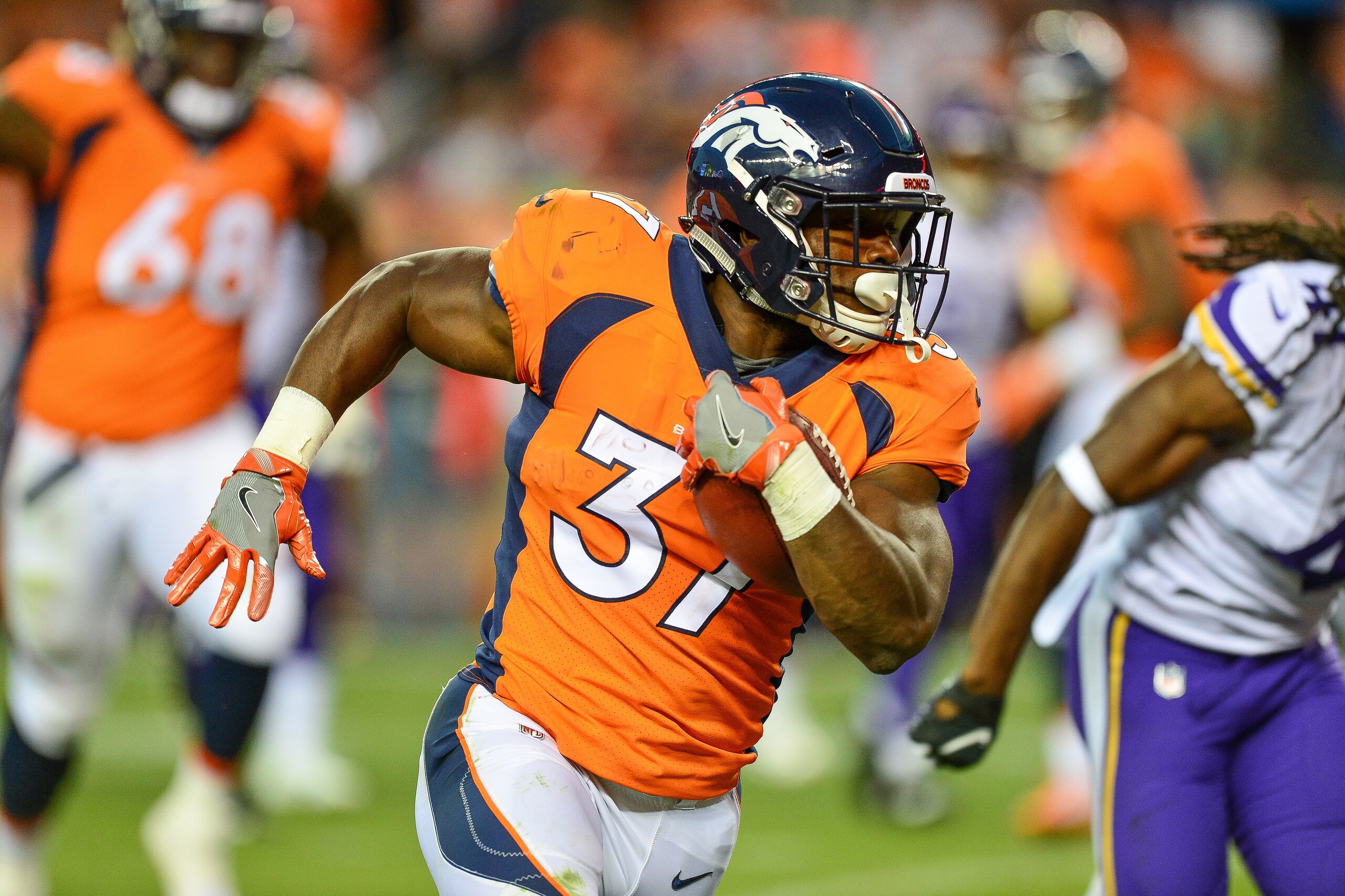 DENVER, CO - AUGUST 11:  Running back Royce Freeman #37 of the Denver Broncos carries for a 23 yard second quarter touchdown against the Minnesota Vikings during an NFL preseason game at Broncos Stadium at Mile High on August 11, 2018 in Denver, Colorado.