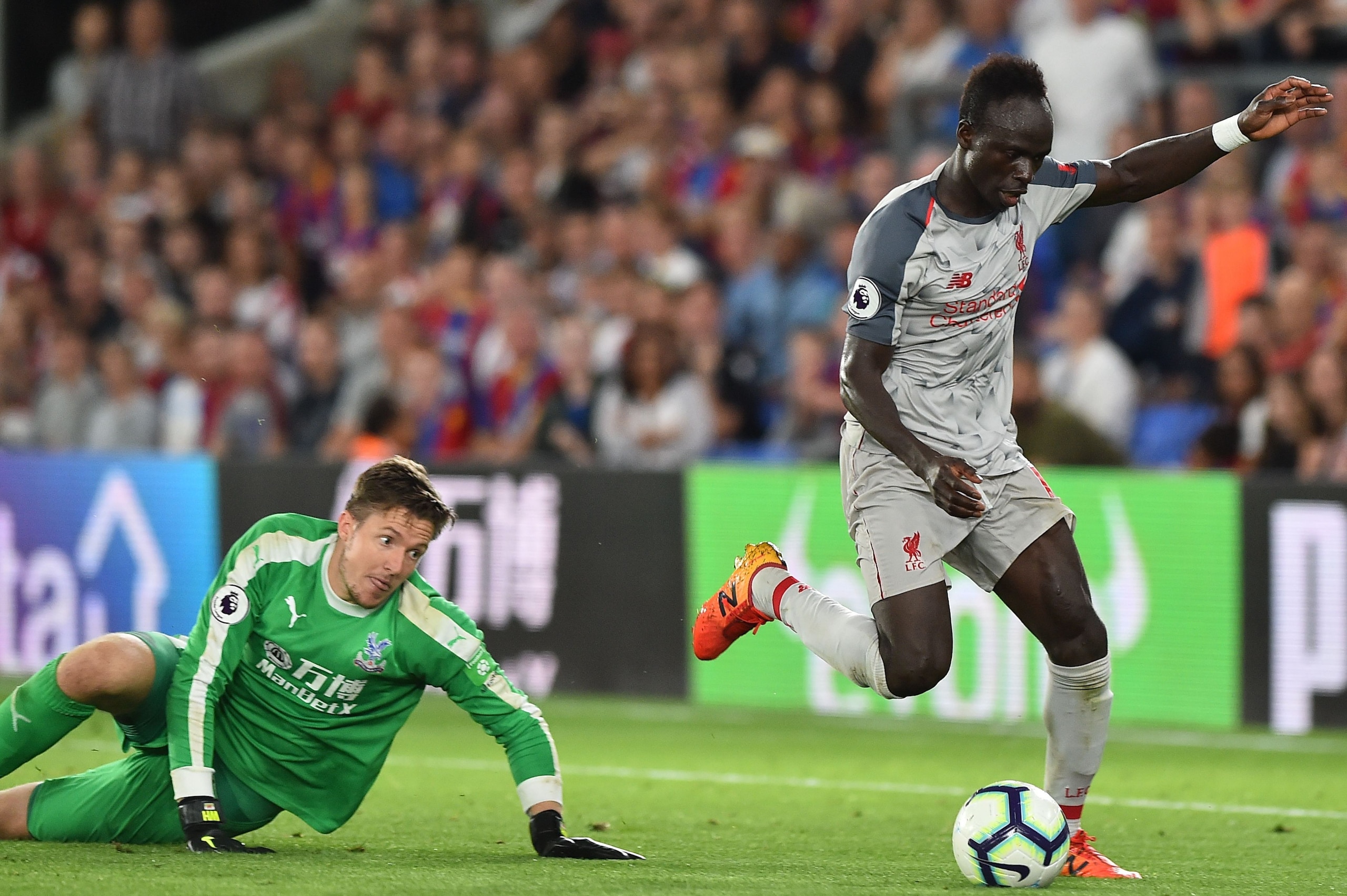 Liverpool's Senegalese striker Sadio Mane (R) goes around Crystal Palace's Welsh goalkeeper Wayne Hennessey (L) to score their second goal during the English Premier League football match between Crystal Palace and Liverpool at Selhurst Park in south Lond
