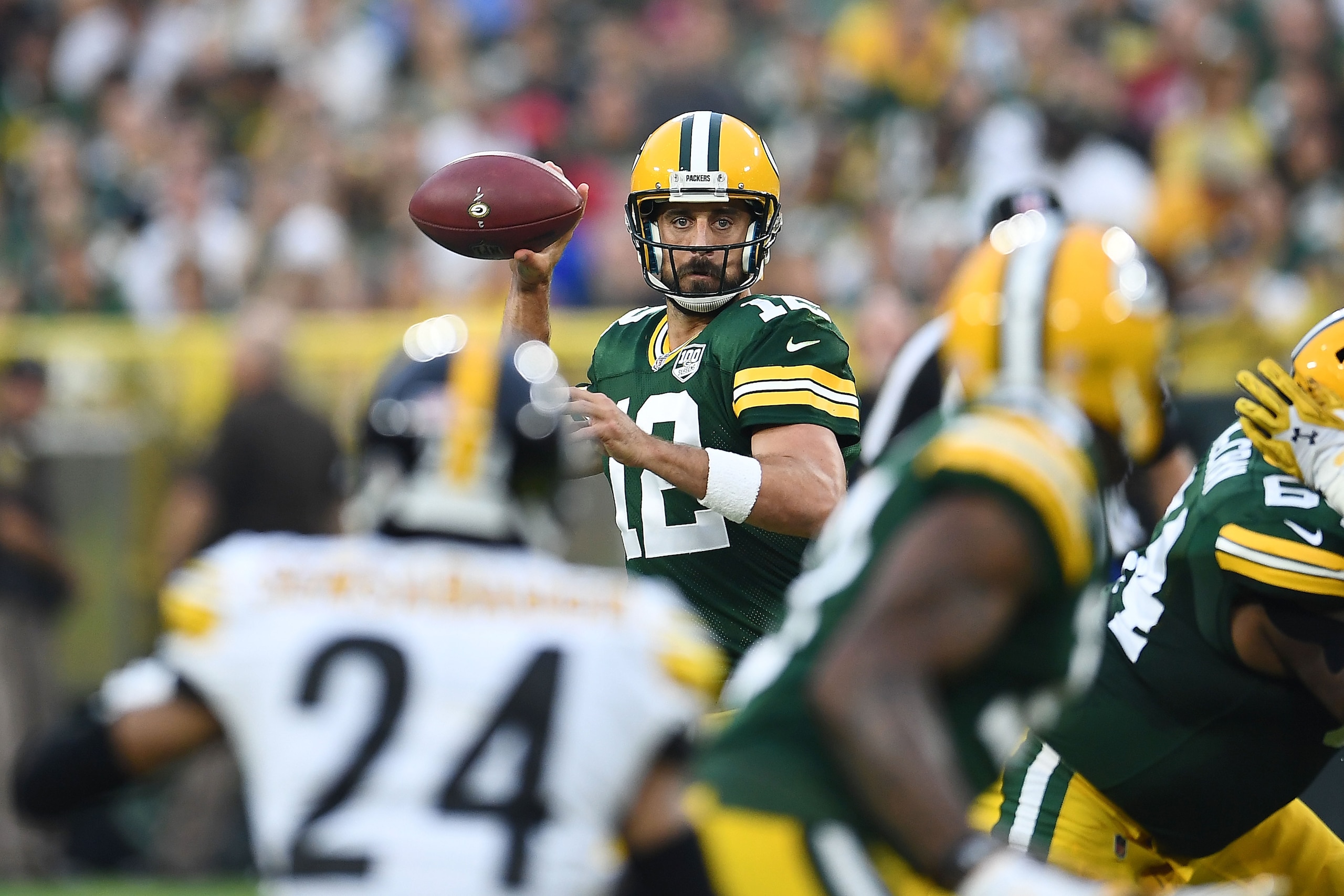 GREEN BAY, WI - AUGUST 16:  Aaron Rodgers #12 of the Green Bay Packers drops back to pass during a preseason game against the Pittsburgh Steelers at Lambeau Field on August 16, 2018 in Green Bay, Wisconsin.  The Packers defeated the Steelers 51-34.  (Phot