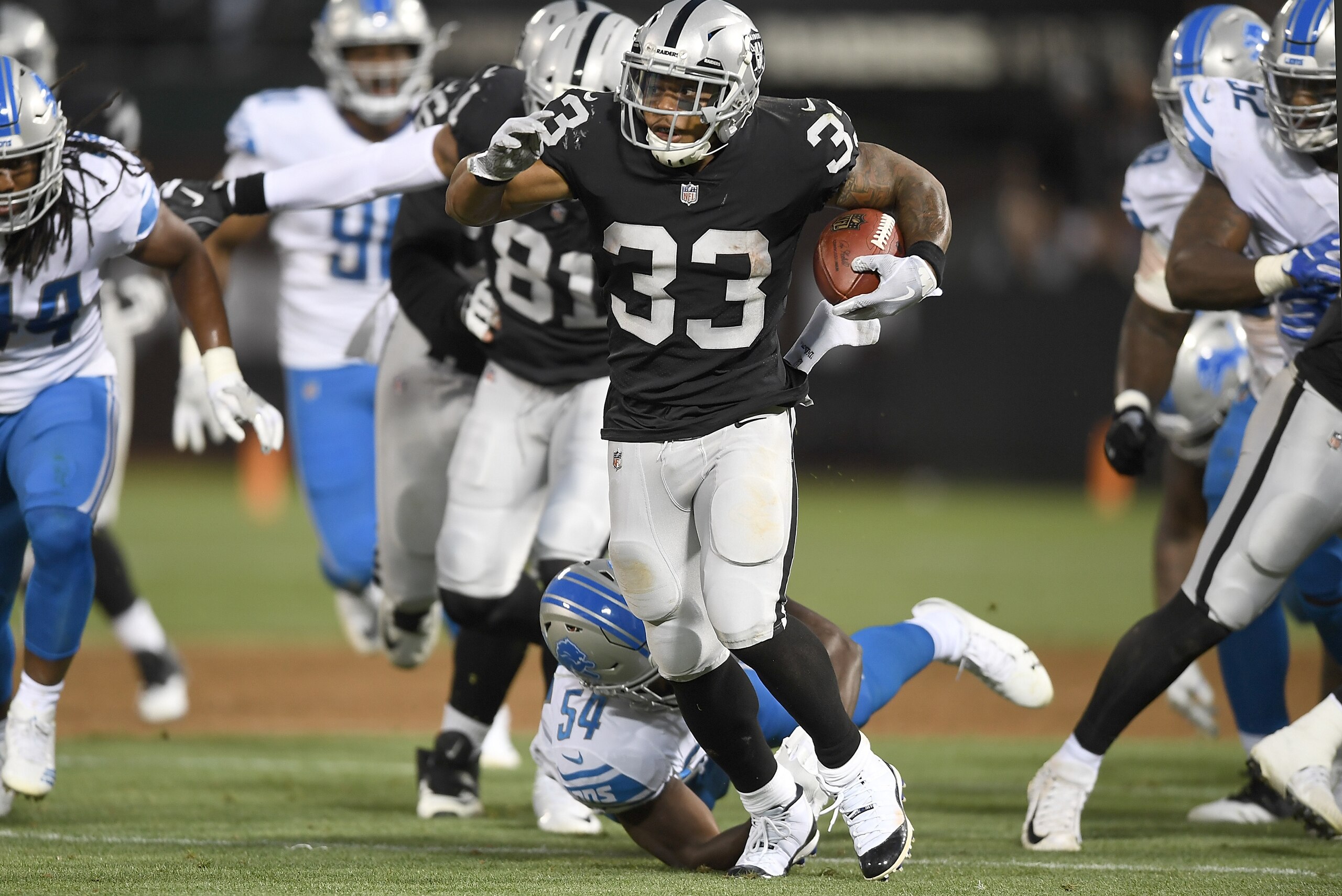 OAKLAND, CA - AUGUST 10:  DeAndre Washington #33 of the Oakland Raiders carries the ball against the Detroit Lions during the first quarter of an NFL preseason football game at Oakland Alameda Coliseum on August 10, 2018 in Oakland, California.  (Photo by