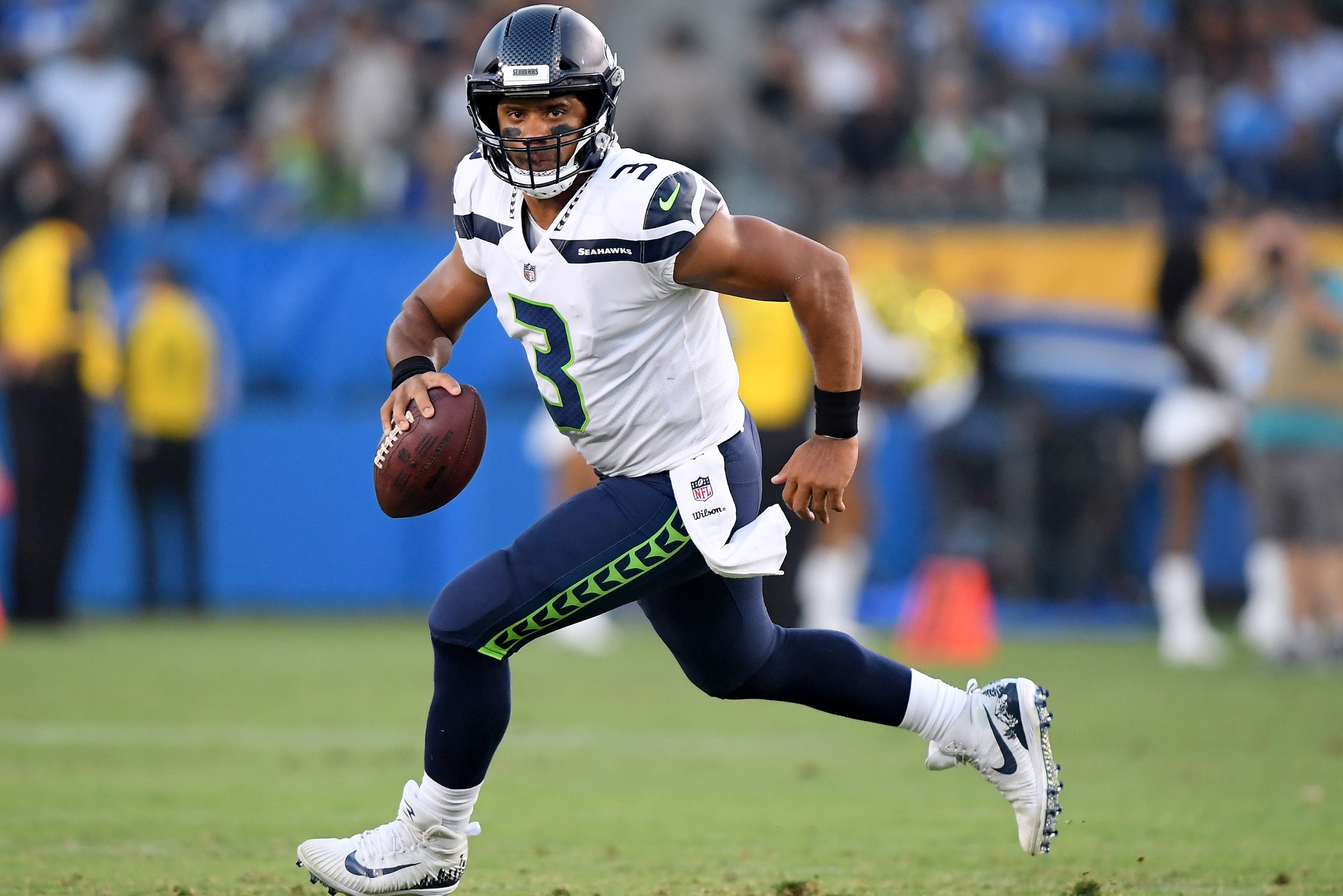 CARSON, CA - AUGUST 18:  Russell Wilson #3 of the Seattle Seahawks scrambles out of the pocket during the first quarter of a presseason game against the Los Angeles Chargers at StubHub Center on August 18, 2018 in Carson, California.  (Photo by Harry How/