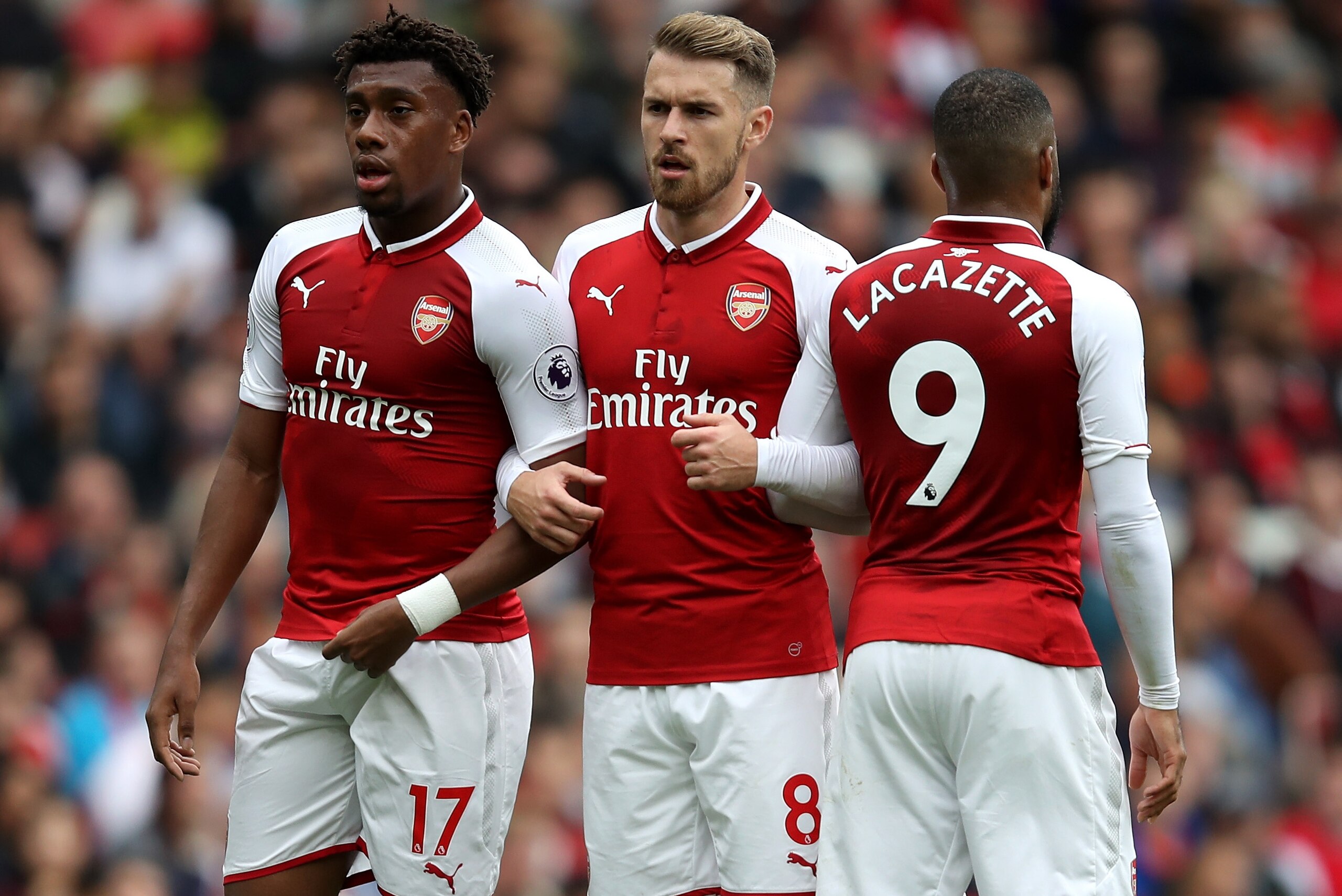 LONDON, ENGLAND - OCTOBER 01: Alex Iwobi of Arsenal, Aaron Ramsey of Arsenal and Alexandre Lacazette of Arsenal form a wall during the Premier League match between Arsenal and Brighton and Hove Albion at Emirates Stadium on October 1, 2017 in London, Engl