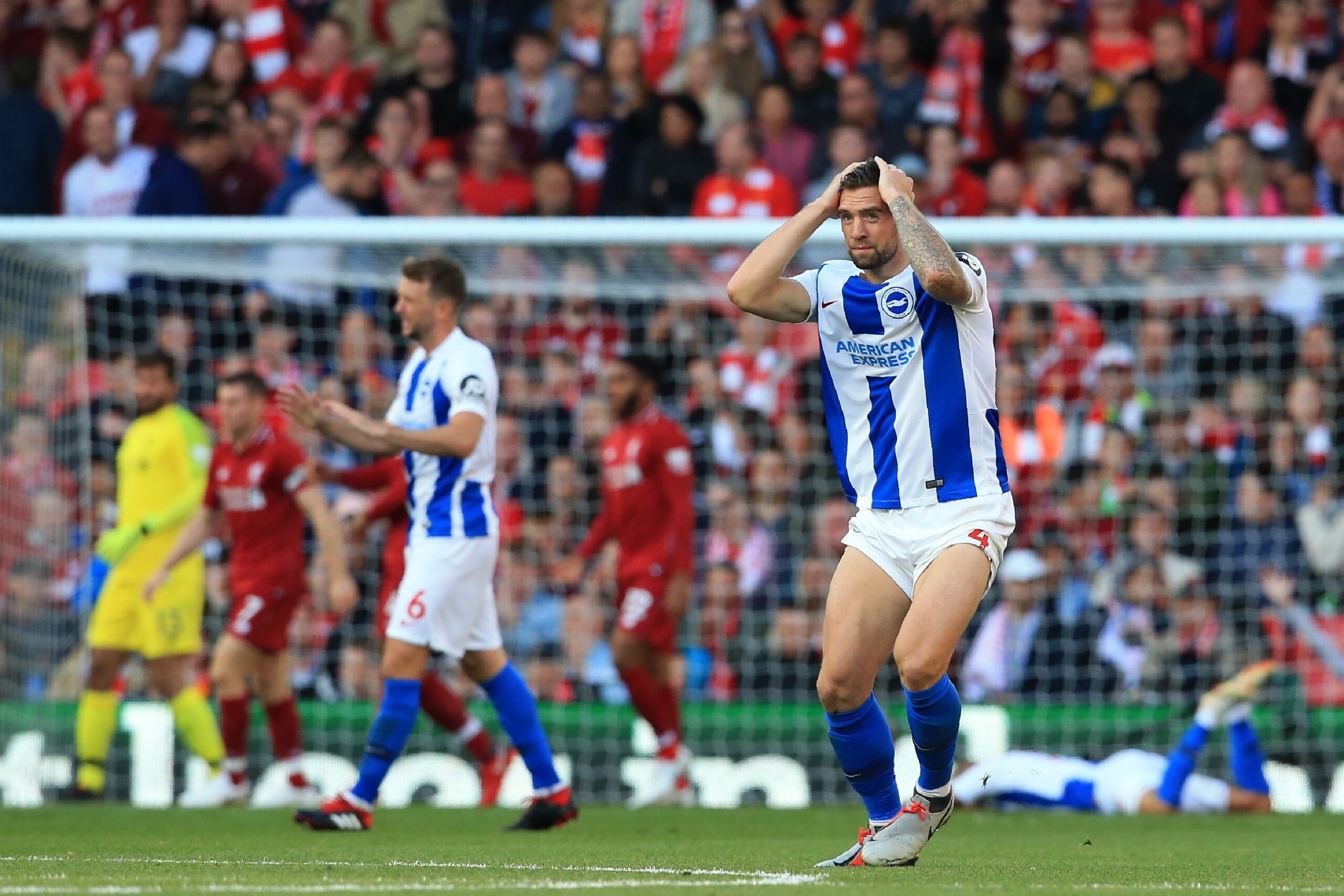 Brighton's Irish defender Shane Duffy (R) reacts to Brighton's French midfielder Anthony Knockaert misses a chance at goal during the English Premier League football match between Liverpool and Brighton and Hove Albion at Anfield in Liverpool, north west 