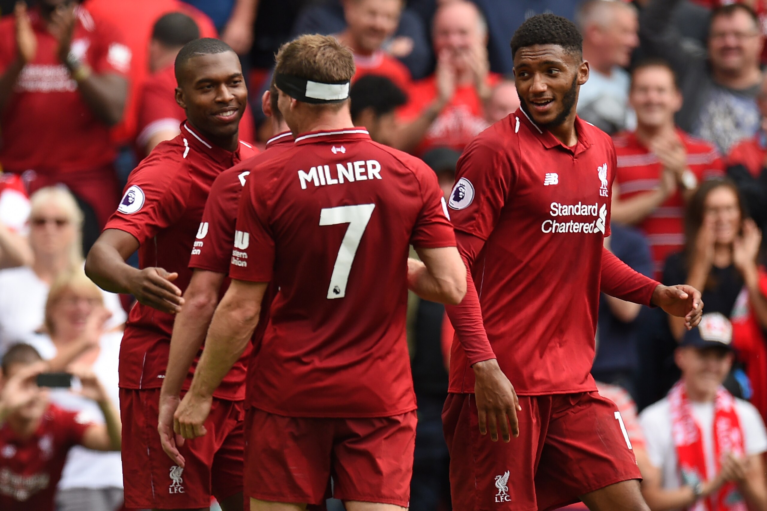 Liverpool's English striker Daniel Sturridge (L) celebrates with teammates after scoring their fourth goal during the English Premier League football match between Liverpool and West Ham United at Anfield in Liverpool, north west England on August 12, 201