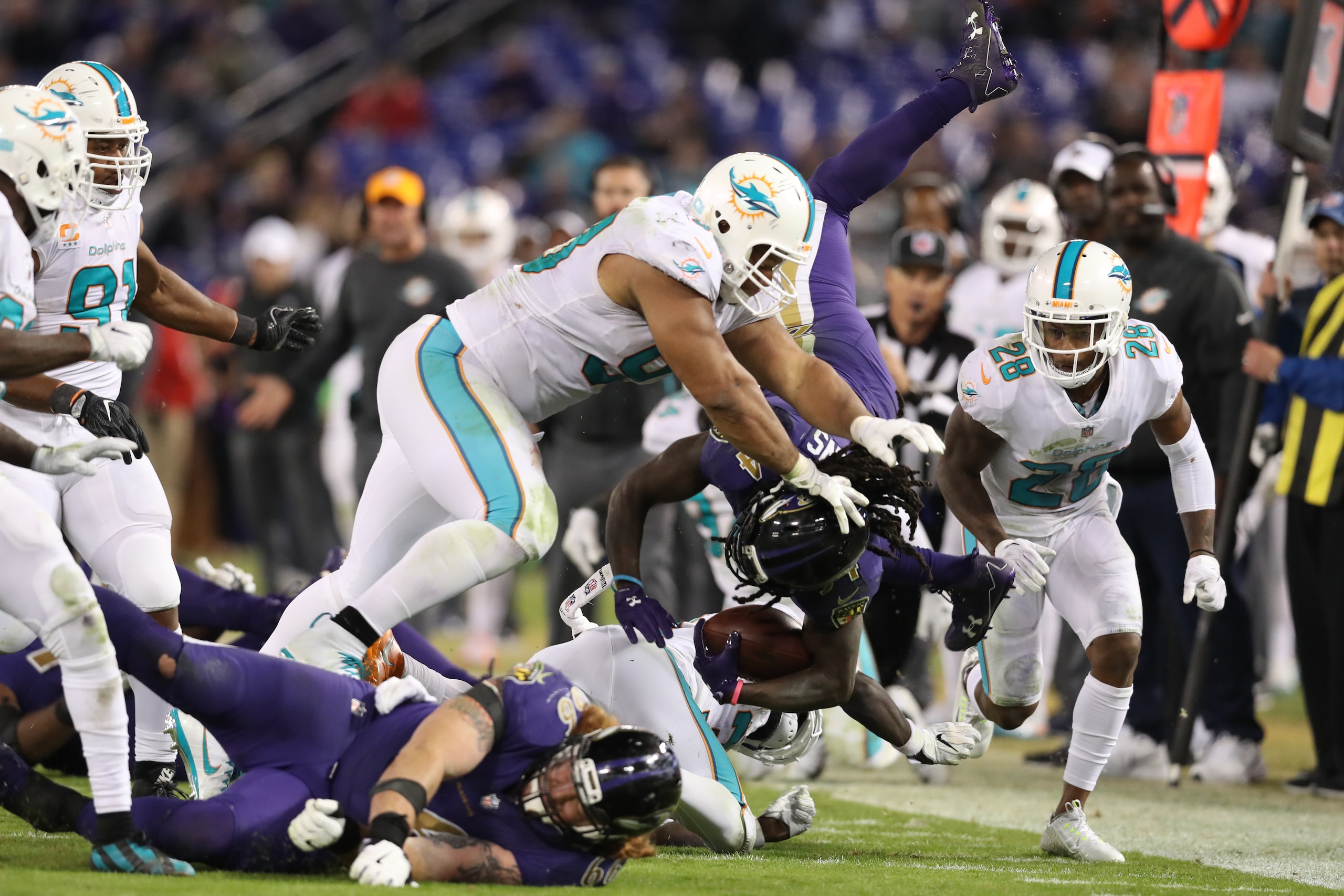 BALTIMORE, MD - OCTOBER 26: Running Back Alex Collins #34 of the Baltimore Ravens is tackled by defensive tackle Ndamukong Suh #93 of the Miami Dolphins in the fourth quarter at M&T Bank Stadium on October 26, 2017 in Baltimore, Maryland. (Photo by Rob Ca BALTIMORE, MD - OCTOBER 26: Running Back Alex Collins #34 of the Baltimore Ravens is tackled by defensive tackle Ndamukong Suh #93 of the Miami Dolphins in the fourth quarter at M&T Bank Stadium on October 26, 2017 in Baltimore, Maryland. (Photo by Rob Ca