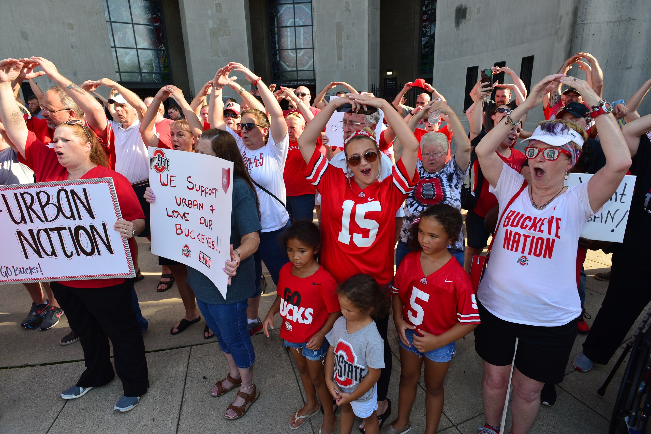 COLUMBUS, OH - AUGUST 6:  Supporters of Ohio State head football coach Urban Meyer sing Carmen Ohio at a rally at Ohio State University on August 6, 2018 in Columbus, Ohio. Meyer is on paid administrative leave after a reports alleging he knew of a 2015 a