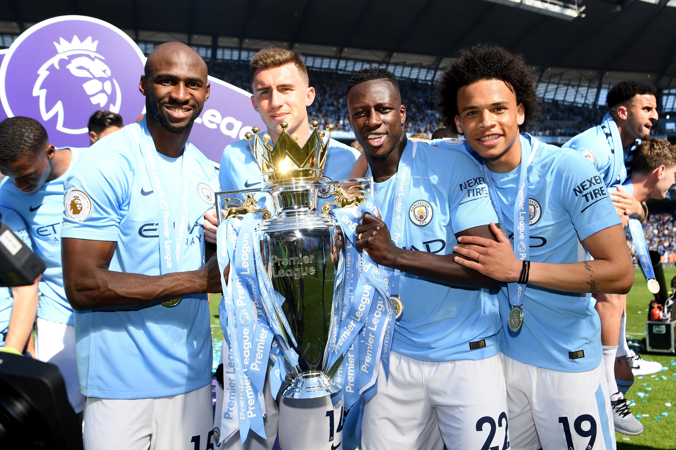MANCHESTER, ENGLAND - MAY 06: Eliaquim Mangala of Manchester City, Aymeric Laporte of Manchester City, Benjamin Mendy of Manchester City and Leroy Sane of Manchester City celebrate with The Premier League Trophy after the Premier League match between Manc