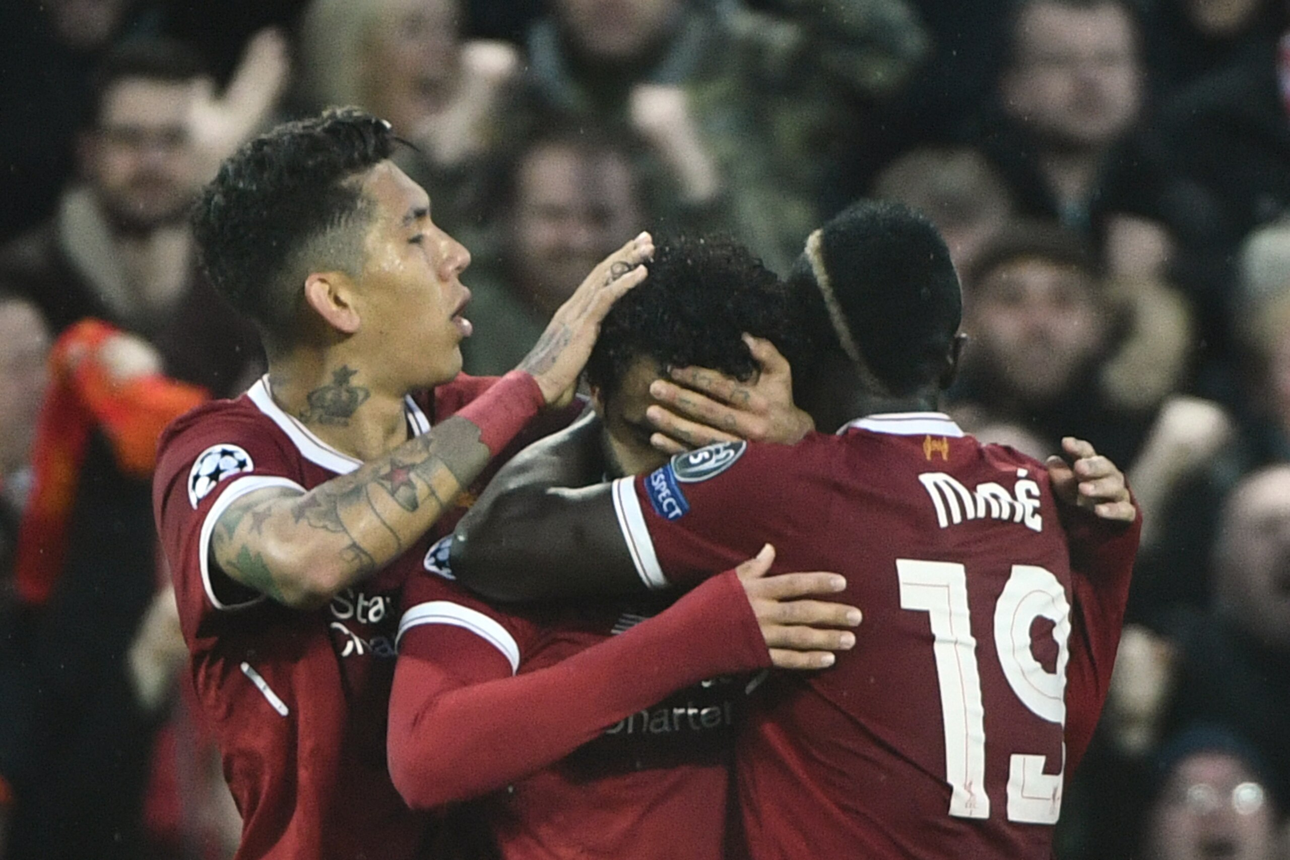 Liverpool's Egyptian midfielder Mohamed Salah (C) celebrates with Liverpool's Brazilian midfielder Roberto Firmino and Liverpool's Senegalese midfielder Sadio Mane (R) after scoring during the UEFA Champions League first leg semi-final football match betw
