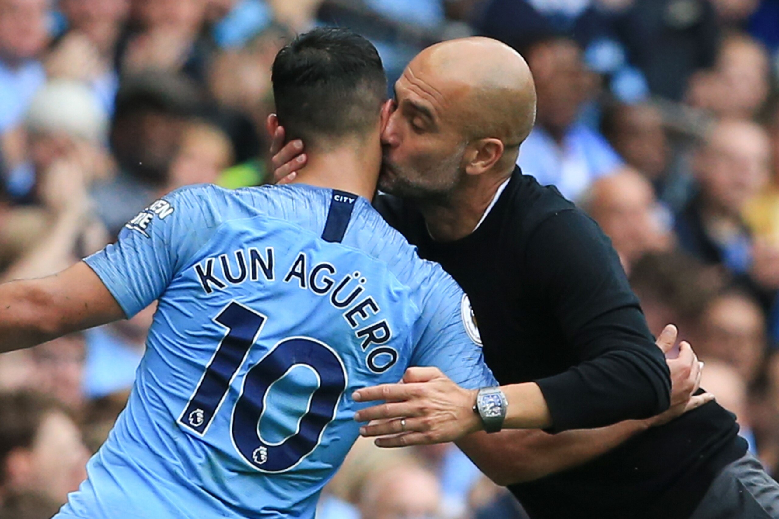 TOPSHOT - Manchester City's Spanish manager Pep Guardiola (R) kisses Manchester City's Argentinian striker Sergio Aguero (L) as Aguero leaves the pitch substituted just after completing his hattrick during the English Premier League football match between