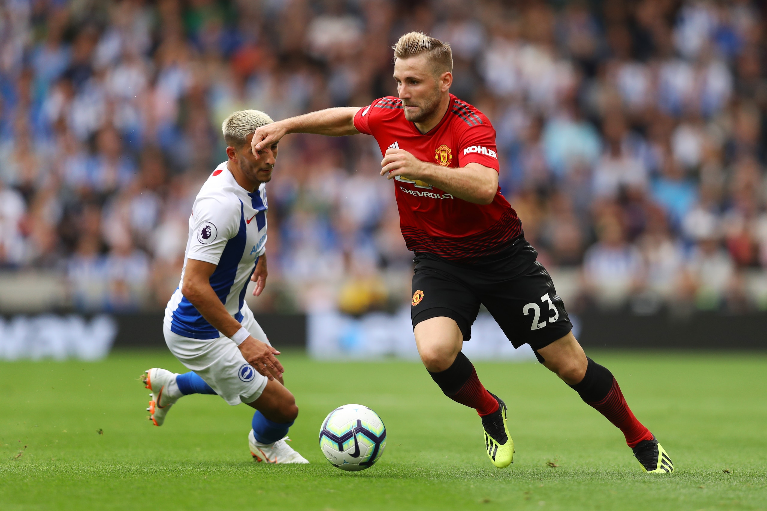BRIGHTON, ENGLAND - AUGUST 19:  Luke Shaw of Manchester United runs past Anthony Knockaert of Brighton & Hove Albion during the Premier League match between Brighton & Hove Albion and Manchester United at American Express Community Stadium on August 19, 2