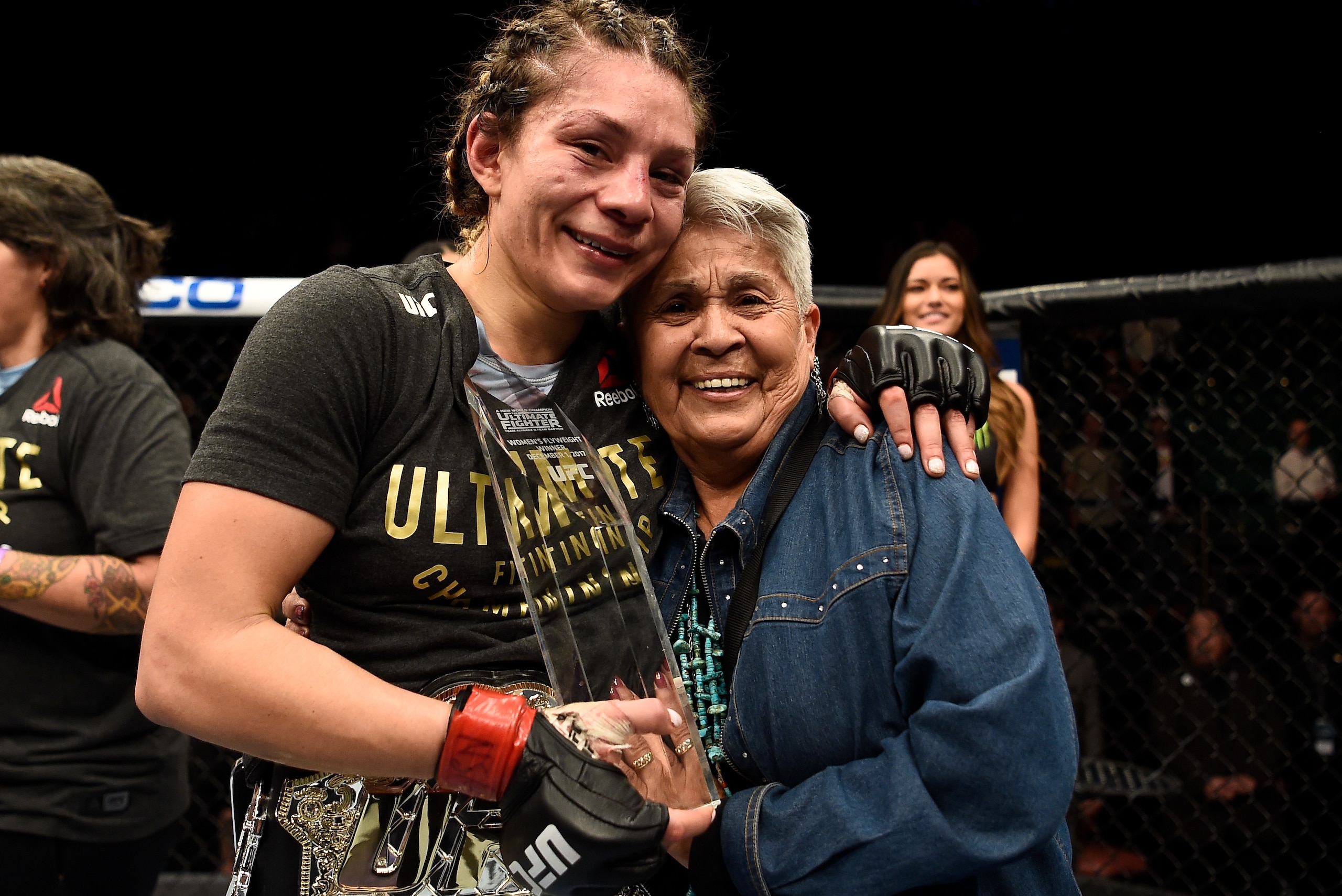 LAS VEGAS, NV - DECEMBER 01:  Nicco Montano celebrates with her grandmother after her unanimous-decision victory over Roxanne Modafferi in their women's flyweight championship bout during the TUF Finale event inside Park Theater on December 01, 2017 in La