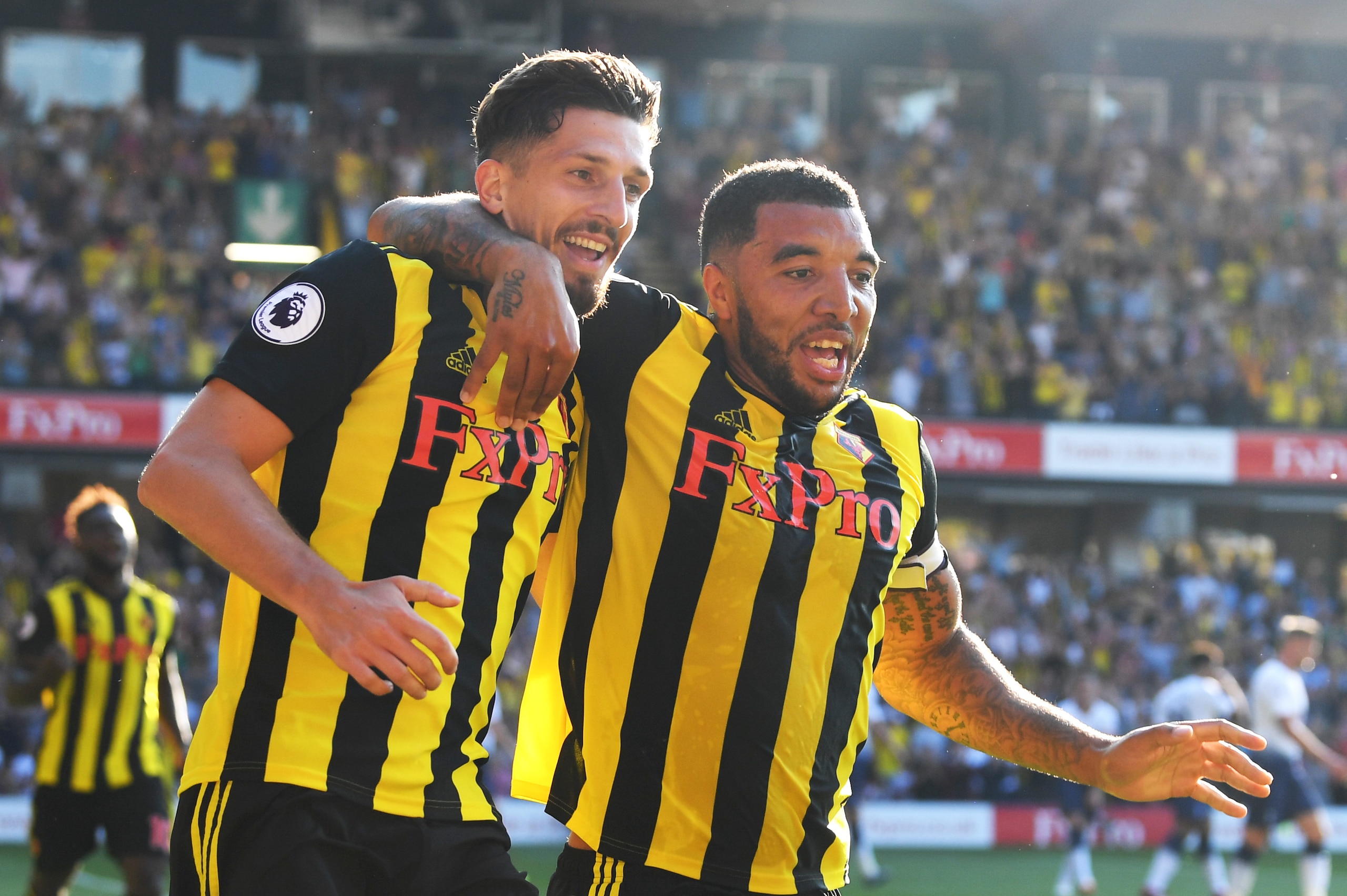WATFORD, ENGLAND - SEPTEMBER 02:  Craig Cathcart of Watford (L) celebrates after scoring his team's second goal with Troy Deeney of Watford during the Premier League match between Watford FC and Tottenham Hotspur at Vicarage Road on September 2, 2018 in W