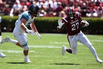 COLUMBIA, SC - SEPTEMBER 01: Ty'Son Williams #27 of the South Carolina Gamecocks runs with the ball against Silas Kelly #29 of the Coastal Carolina Chanticleers at Williams-Brice Stadium on September 1, 2018 in Columbia, South Carolina. (Photo by Lance Ki