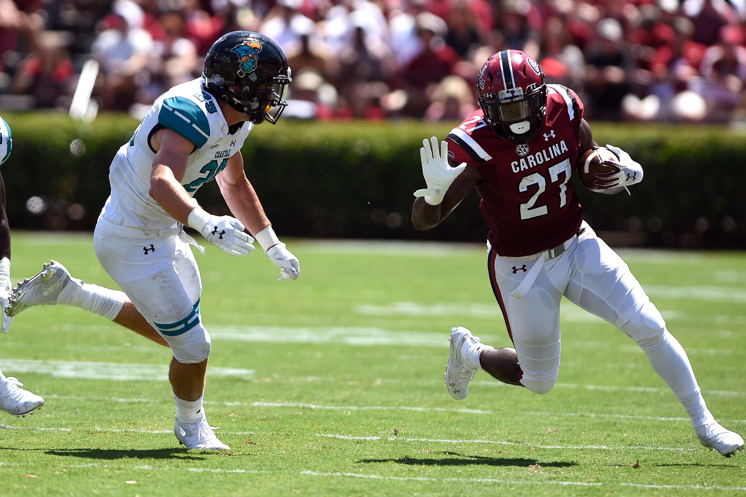 COLUMBIA, SC - SEPTEMBER 01: Ty'Son Williams #27 of the South Carolina Gamecocks runs with the ball against Silas Kelly #29 of the Coastal Carolina Chanticleers at Williams-Brice Stadium on September 1, 2018 in Columbia, South Carolina. (Photo by Lance Ki