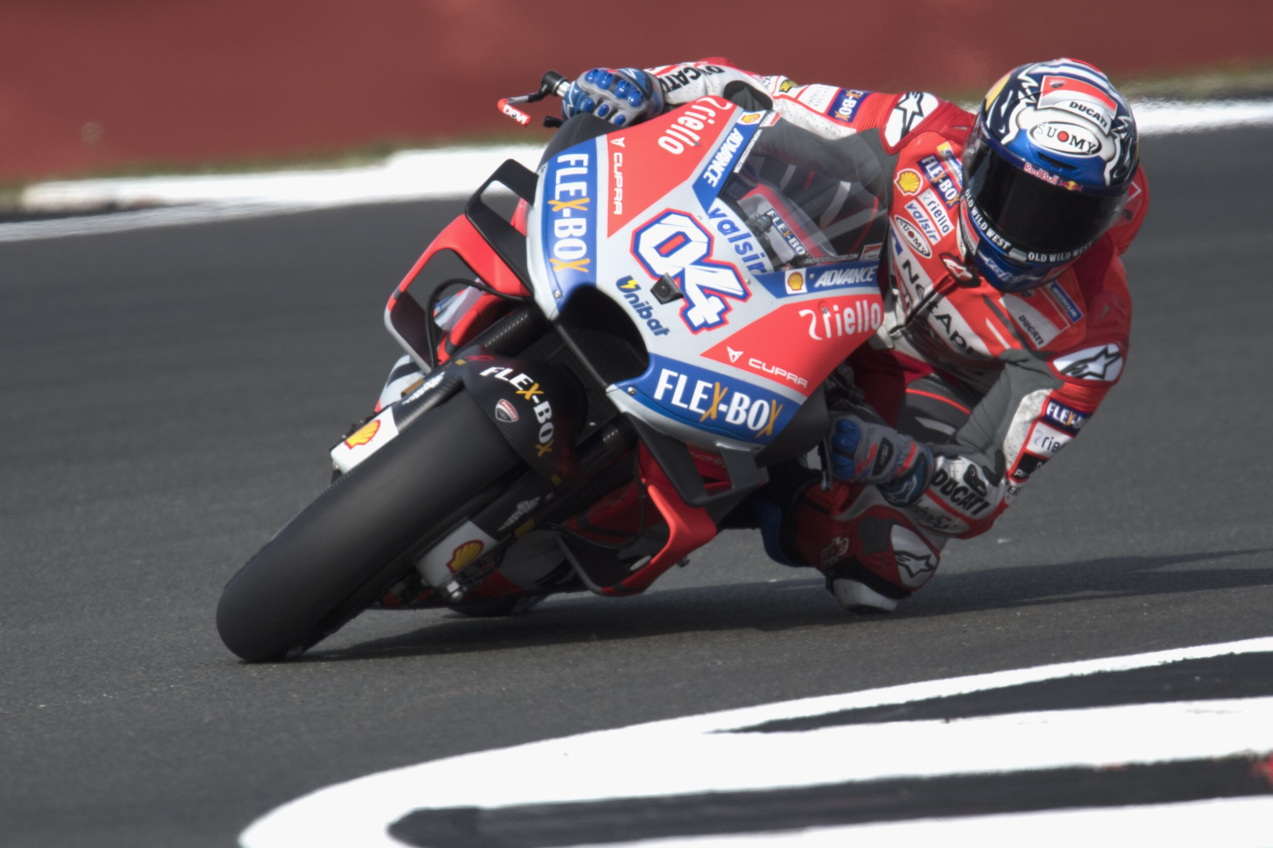 NORTHAMPTON, ENGLAND - AUGUST 24:   Andrea Dovizioso of Italy and Ducati Team rounds the bend during the  MotoGp Of Great Britain - Free Practice at Silverstone Circuit on August 24, 2018 in Northampton, England.  (Photo by Mirco Lazzari gp/Getty Images)