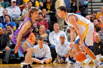 OAKLAND, CA - FEBRUARY 07: Stephen Curry #30 of the Golden State Warriors dribbles the ball against Steve Nash #13 of the Phoenix Suns on February 7, 2011 at Oracle Arena in Oakland, California. NOTE TO USER: User expressly acknowledges and agrees that, b